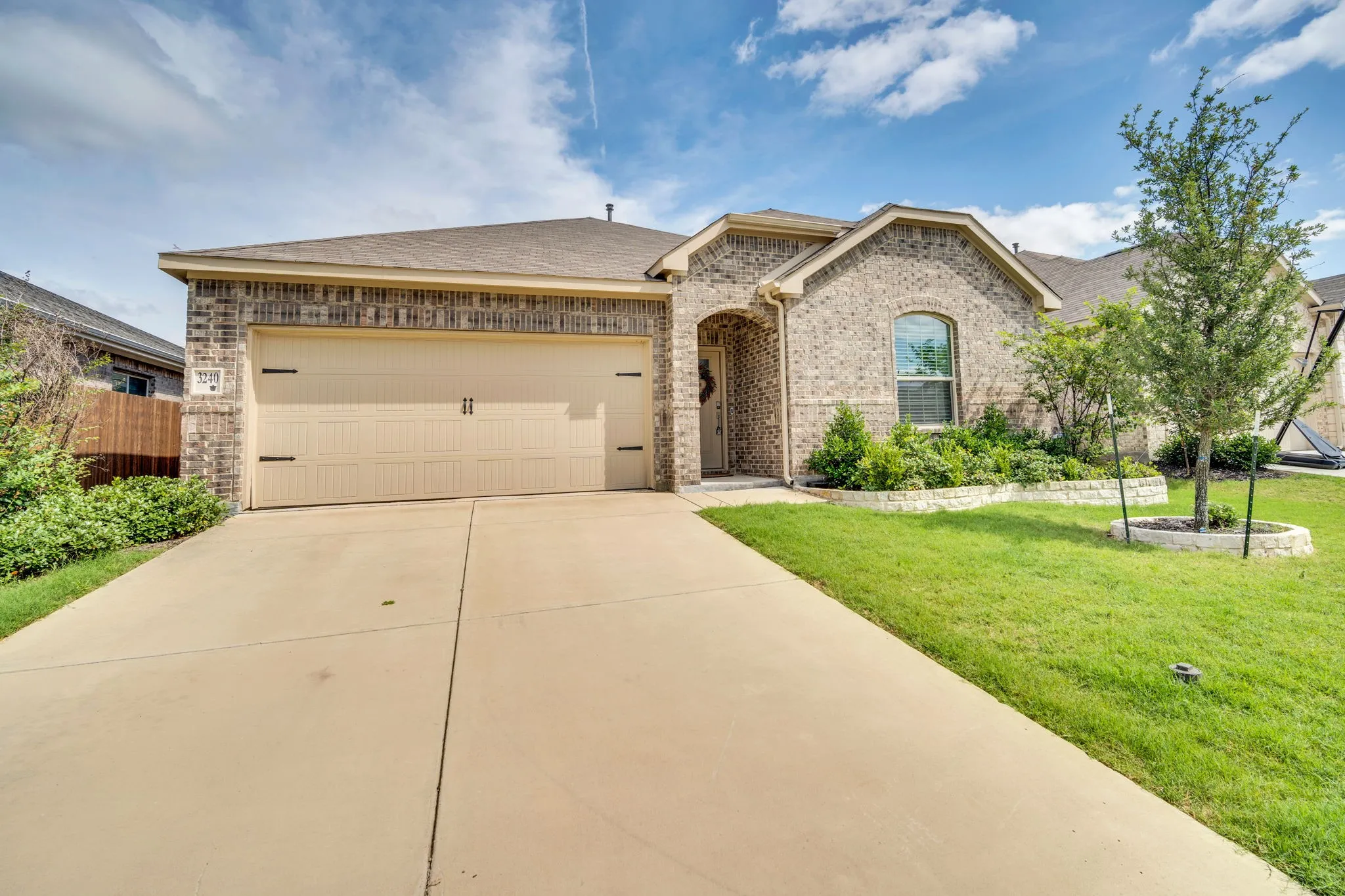 Brick veneer exterior with a two-car garage