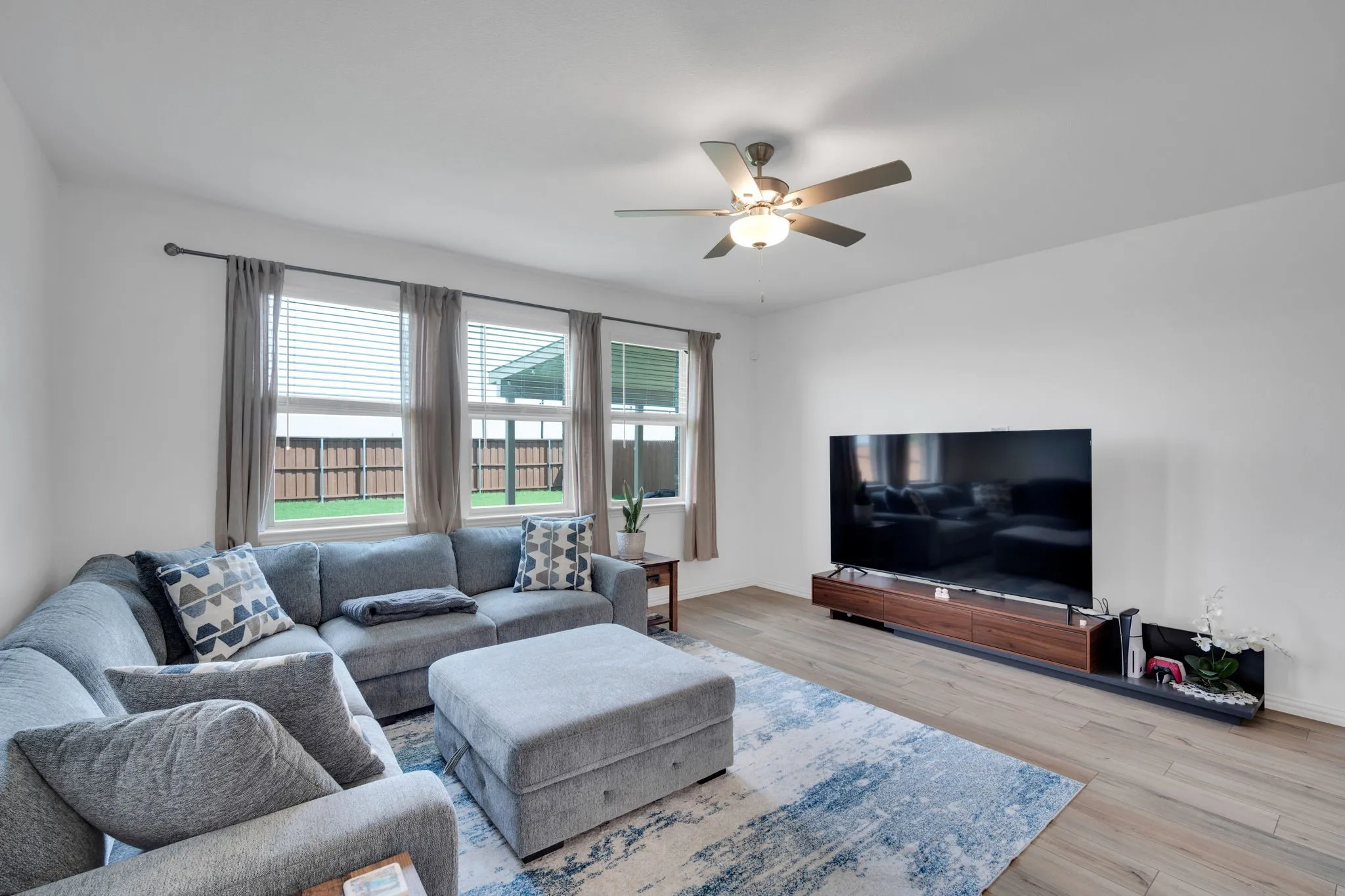 Bright living area featuring wood-finish flooring and multiple windows