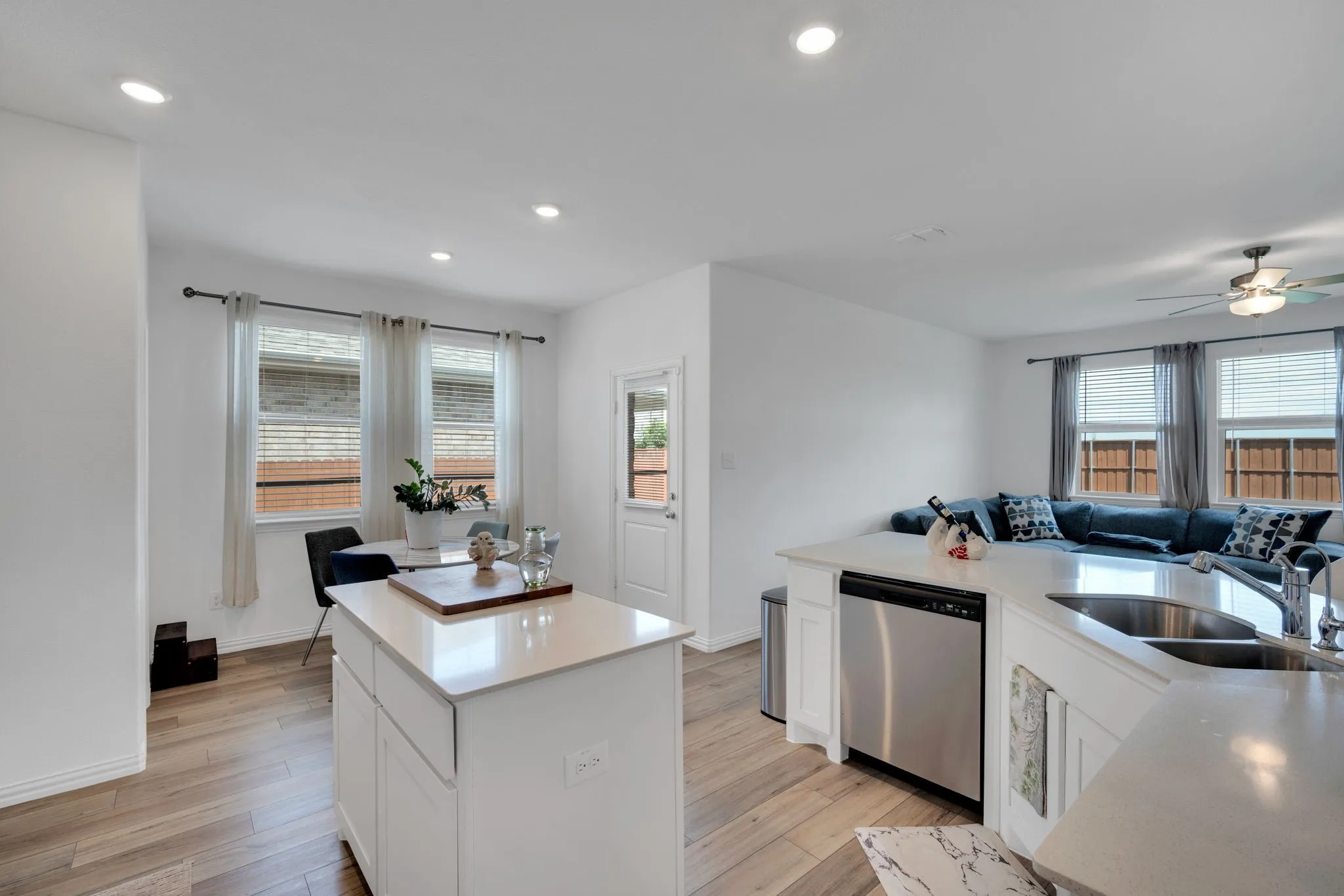 Open-concept living space featuring wood-finish flooring, recessed lighting, and a modern ceiling fan