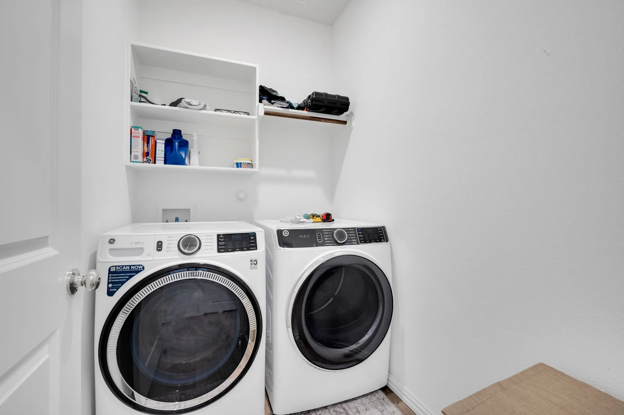 Dedicated laundry area featuring a white front-load washer and dryer
