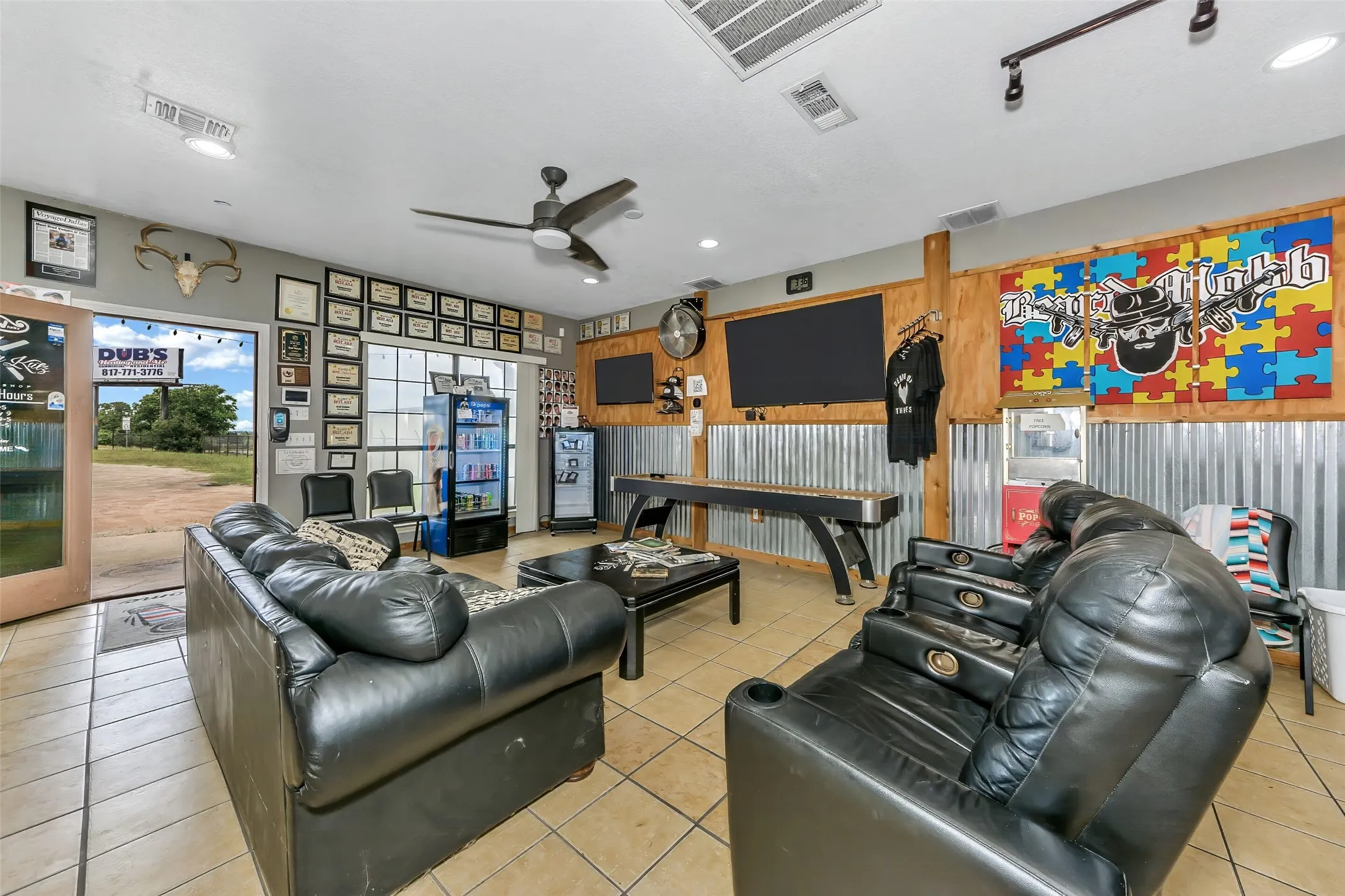 Spacious interior featuring tile flooring, track lighting, and a ceiling fan