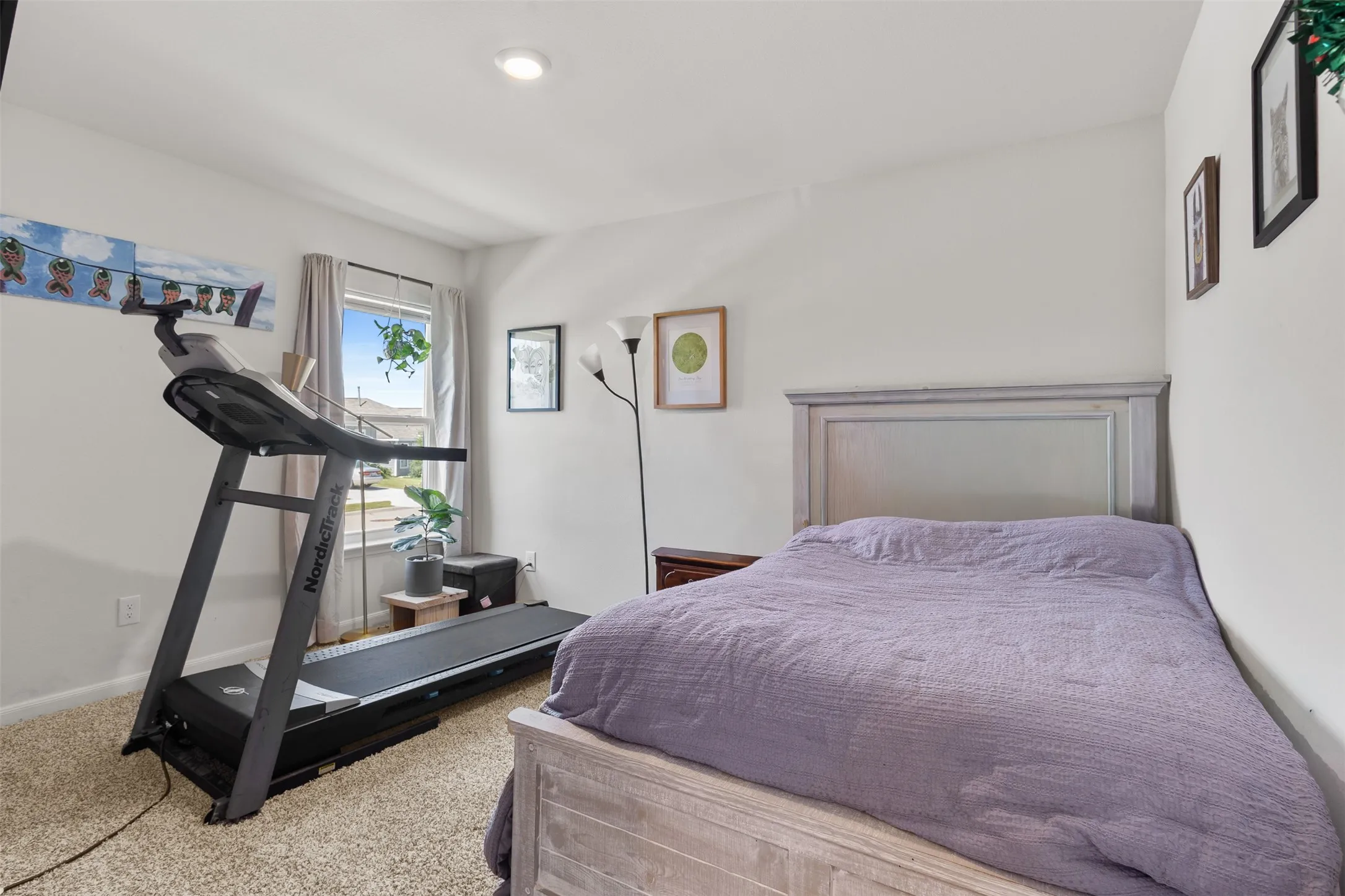 Carpeted room featuring a window with curtain, recessed lighting, and a neutral color palette
