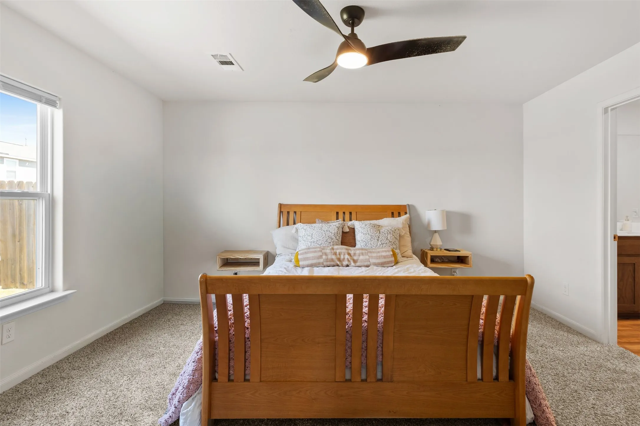 Bright interior space with light-colored walls and soft carpet flooring