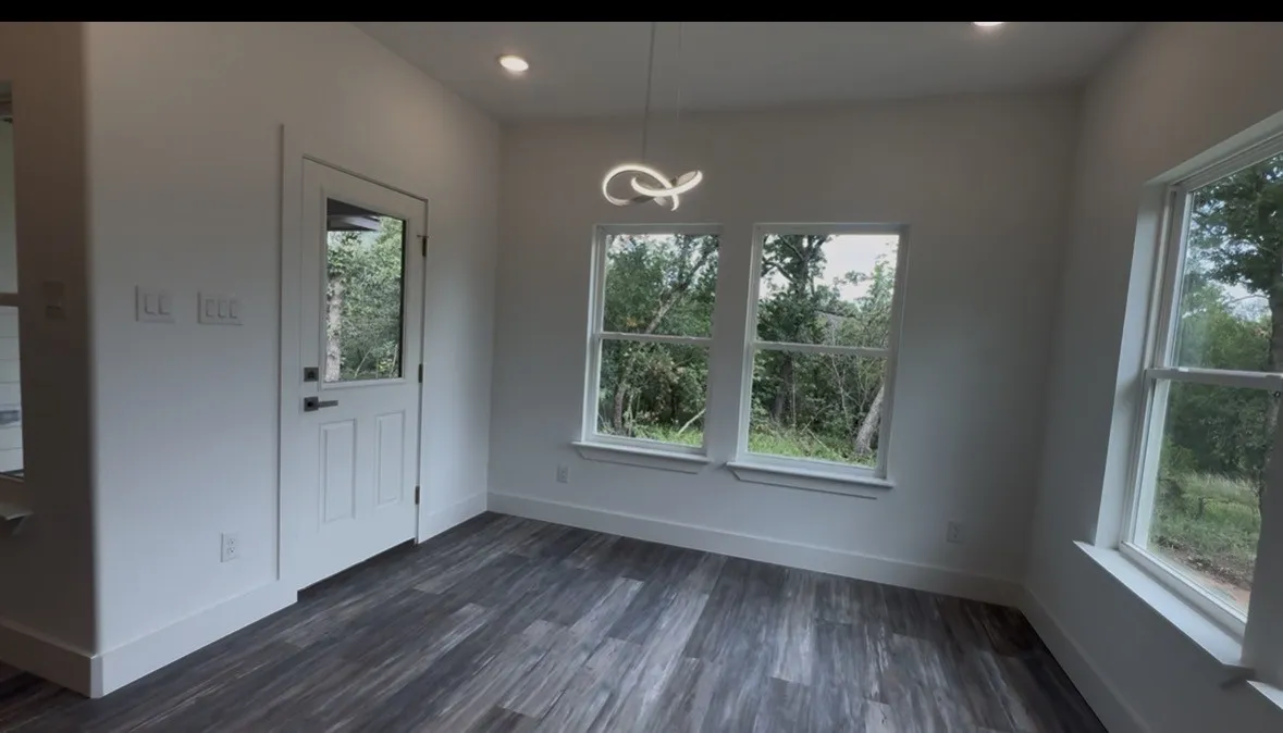 Interior space with wood-finish flooring, recessed lighting, and a modern ceiling fixture