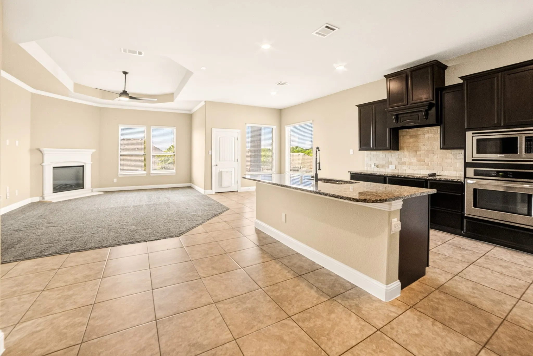 The heart of the home with is the open concept Living-Kitchen-Dining combo Living has custom electric fireplace that urns on with flip of switch...access to utility room and master is left of living room and access to back patio and juge yard on right side behind the dining