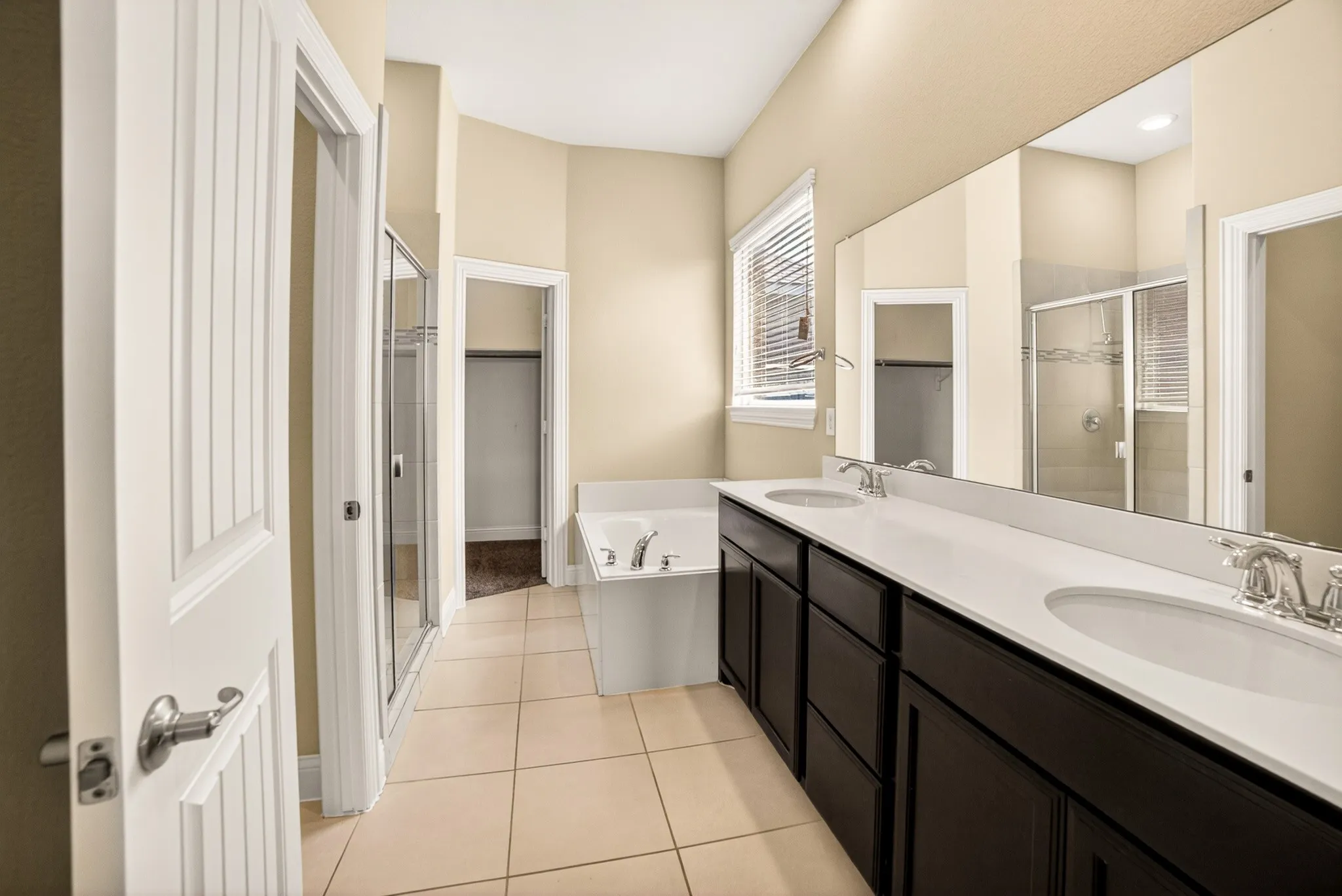 Luxury master bathroom...relax in the oversized garden tub with recliner back and armrests. Spread out your things on the double sink 7ft long vanity with full width mirror. Separate large shower on the right and privacy toilet area