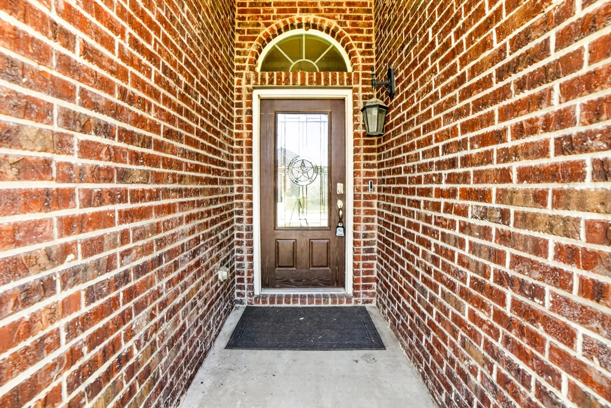 Fancy front door with leaded glass, sunburst window above, 10+ft ceilings add to flare.