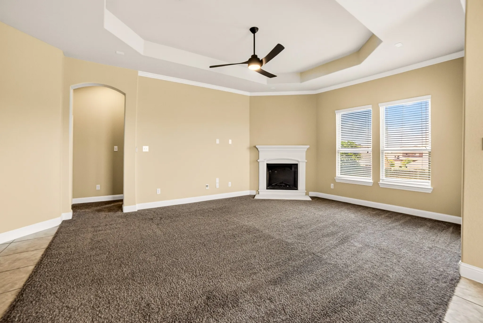 Gorgeous Living room with custom recessed ceiling, corner firpleace with mantle and landing turns on with flip of switch