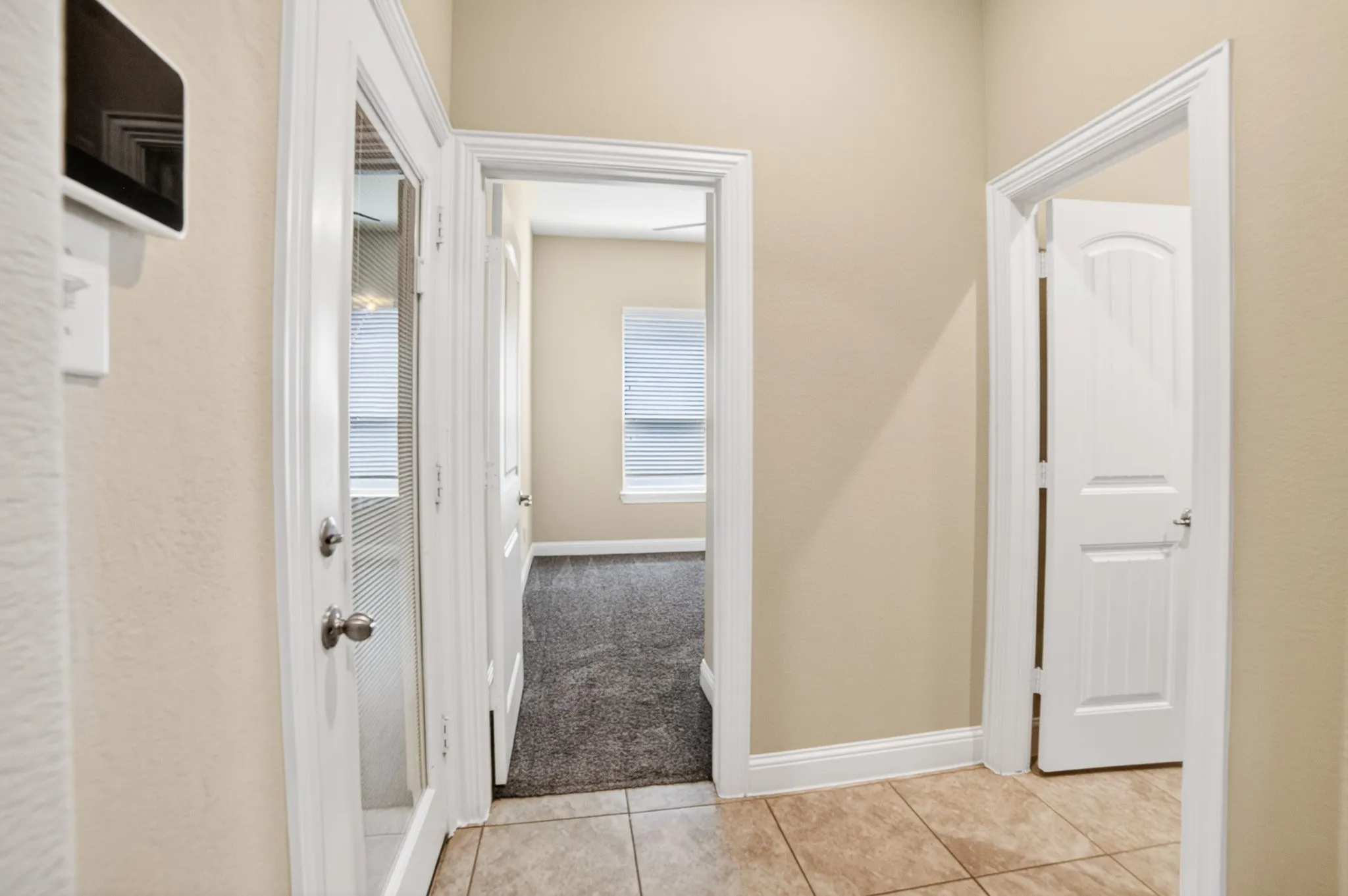 Hallway/mudud area entry from garage on left, 4th bedroom and 3rd bathroom on right