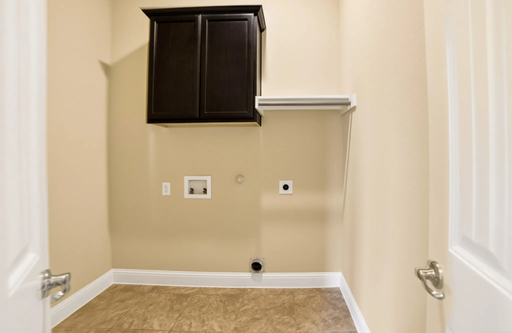 Full size washer and dryer area, added cabinets and clothes hanging bar and room on the left for ironing board