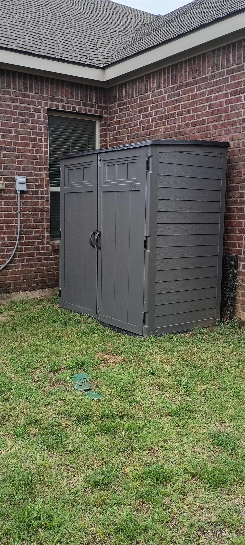 In hidden side yard is a Large double door shed and tall enough to walk into with plenty of storage for all lawn tools