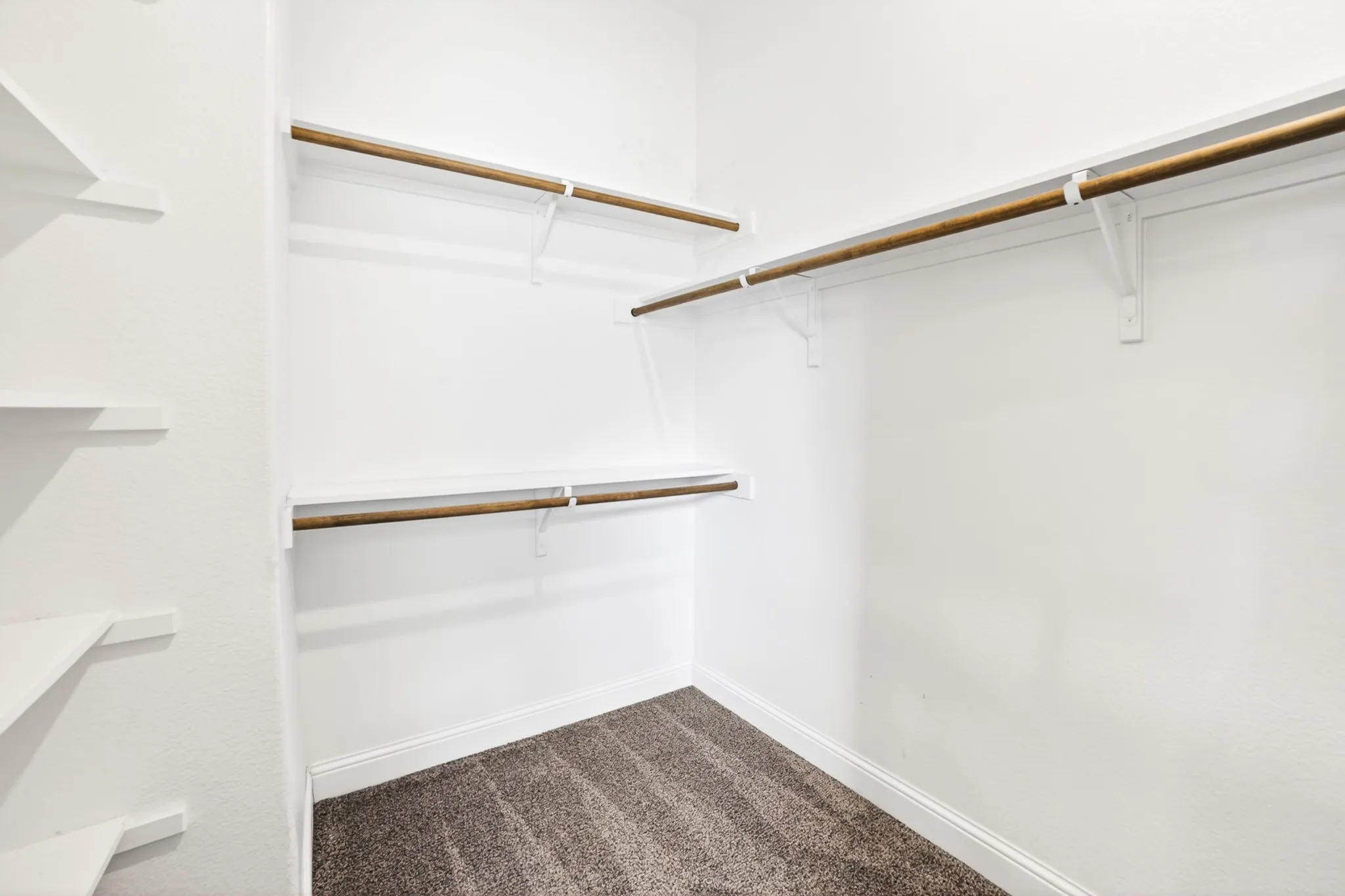 Master closet also has other side of huge walkin closet with his and her sides with high and low bars