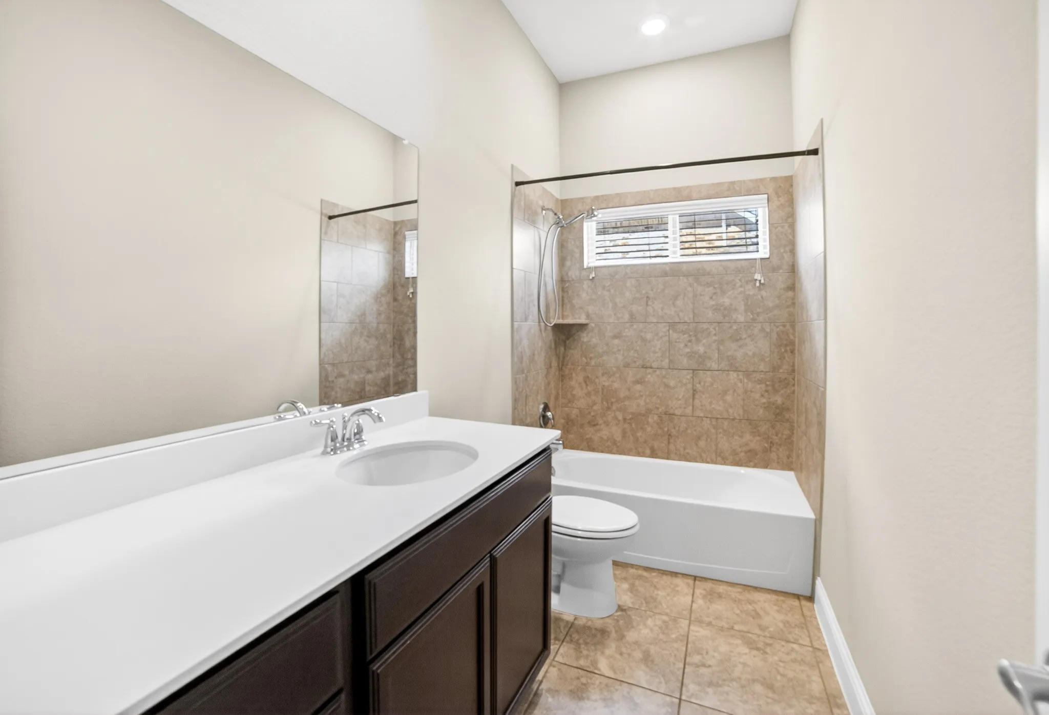 Front large 3rdd bathroom with lots of counter space, tiled floors and tiled surround tub-shower. This bathroom is between 2nd & 3rd bedrooms so all 4 bedrooms have privacy with no adjoining walls
