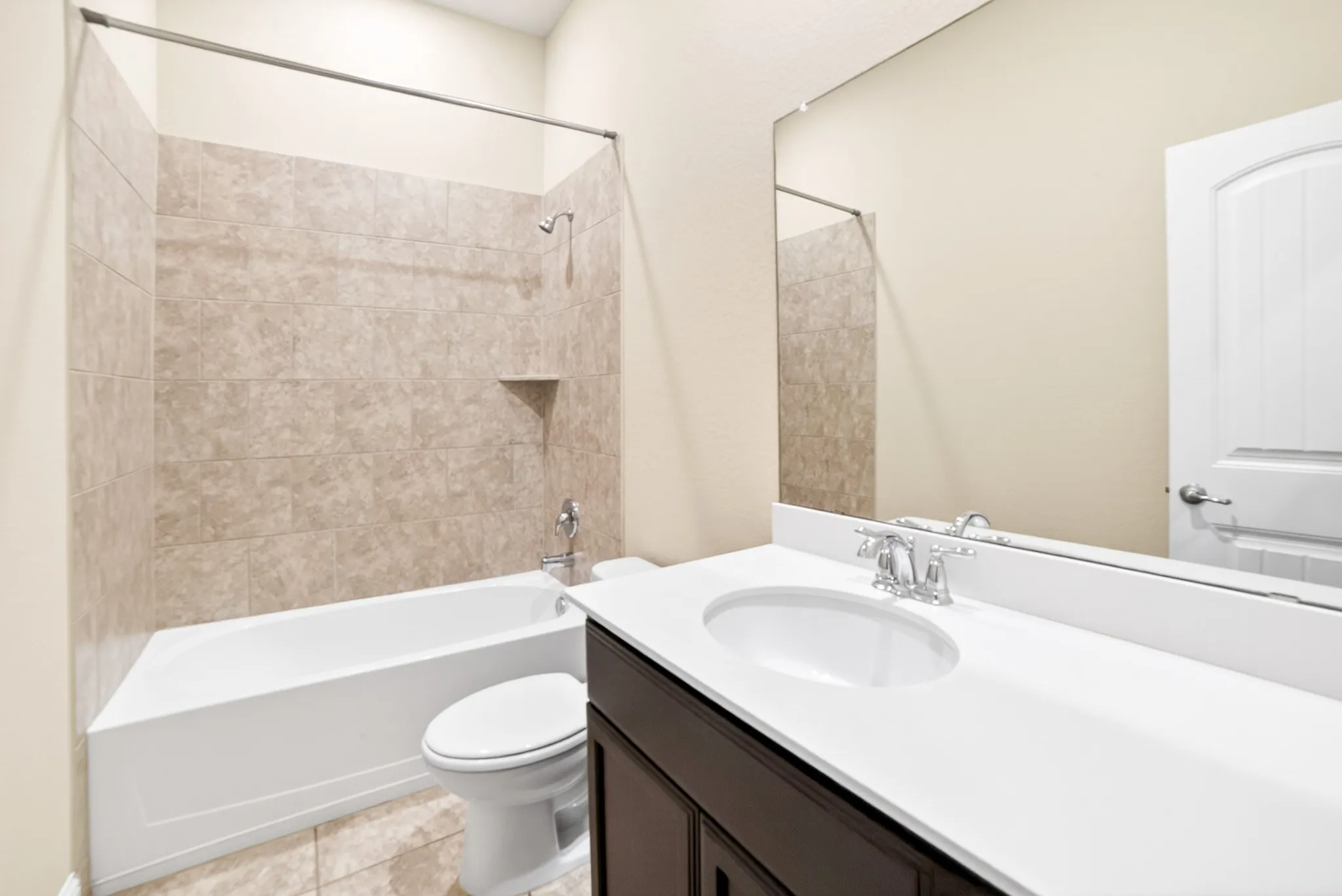 3rd bathroom next to 4th bedroom and entry from garage also has area for table and display or mudroom style cabinet for shoes and coat hangers just outside of bathroom and accross from garage door entry