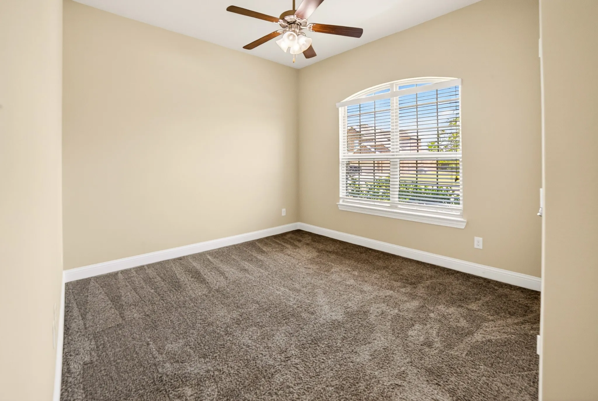 Front bedroom #2 with large arched window overlooking front yard