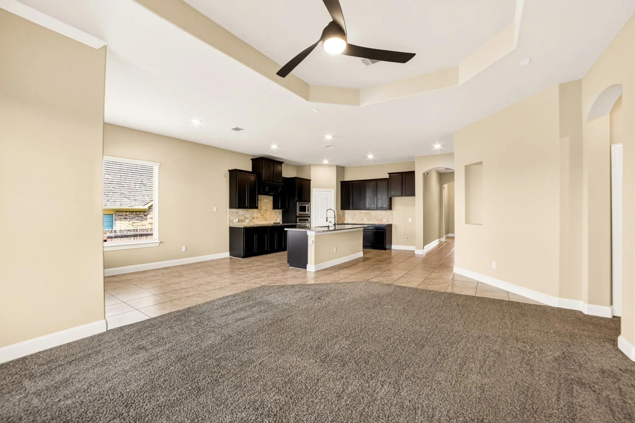 Large dining area with room for big table that can easily sit 6-8 and 4 more at the breakfast counter overhang on the island....view from inside living room