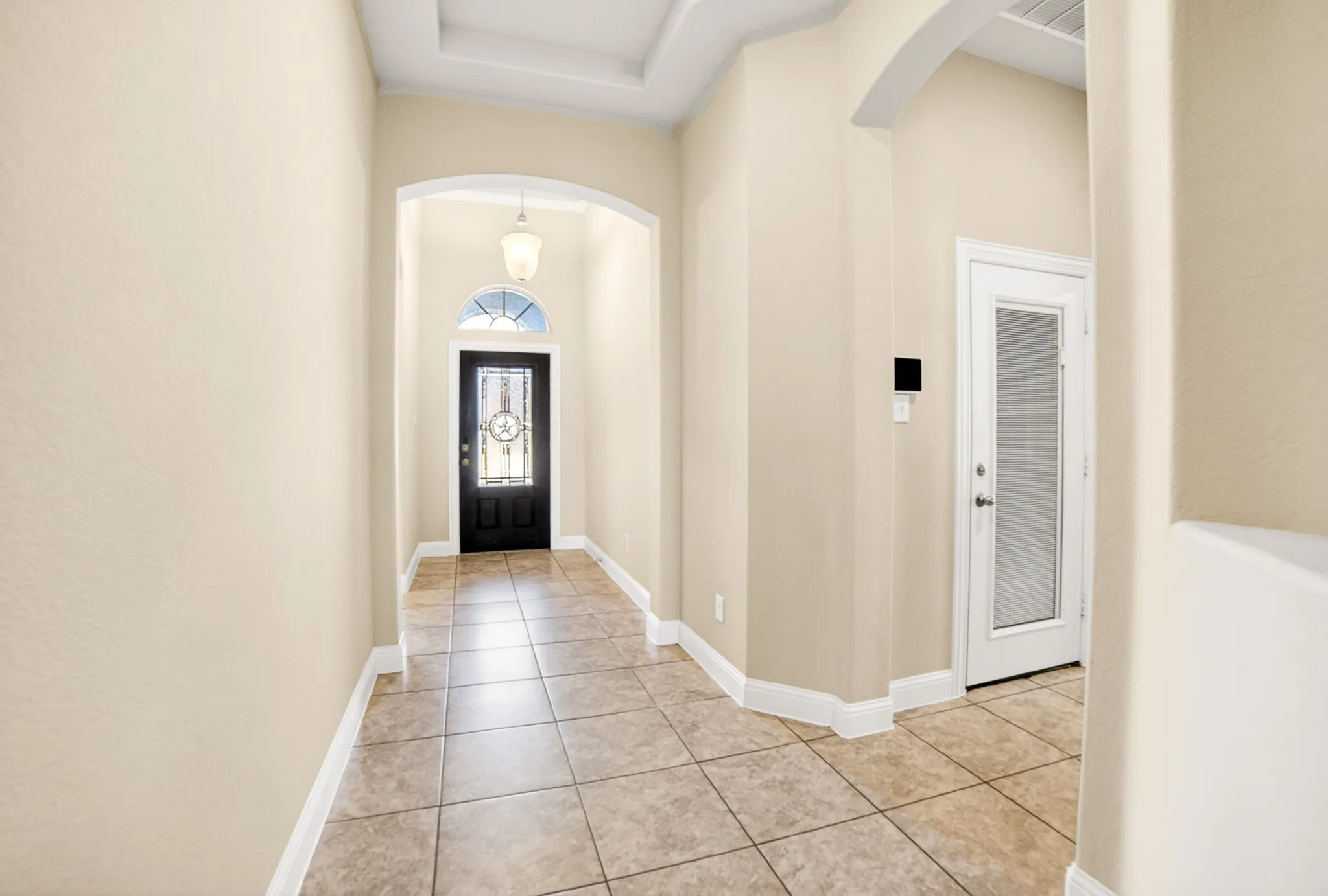 Entry from inside the home with 2 bedrooms on the left with bathroom in between and another bedroom and bathroom on the right in front of gare entry door