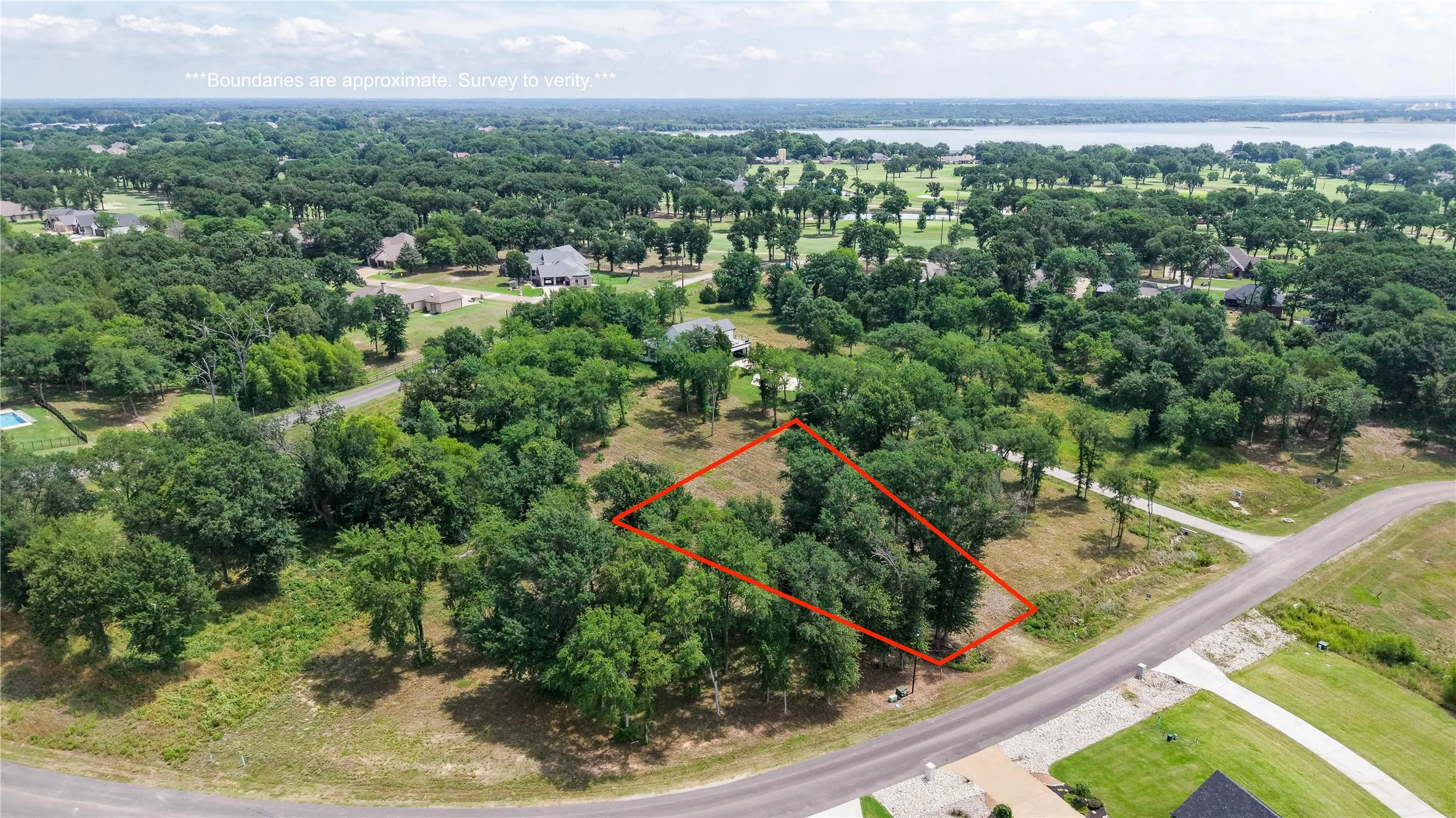 Aerial photo featuring the large lot size, beautiful trees, and peaceful neighborhood setting