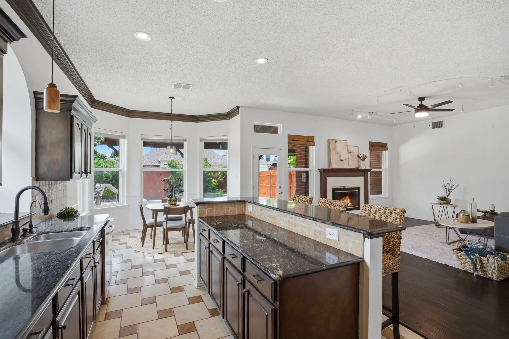 Gourmet kitchen featuring dark wood cabinetry, granite countertops, and a tile backsplash