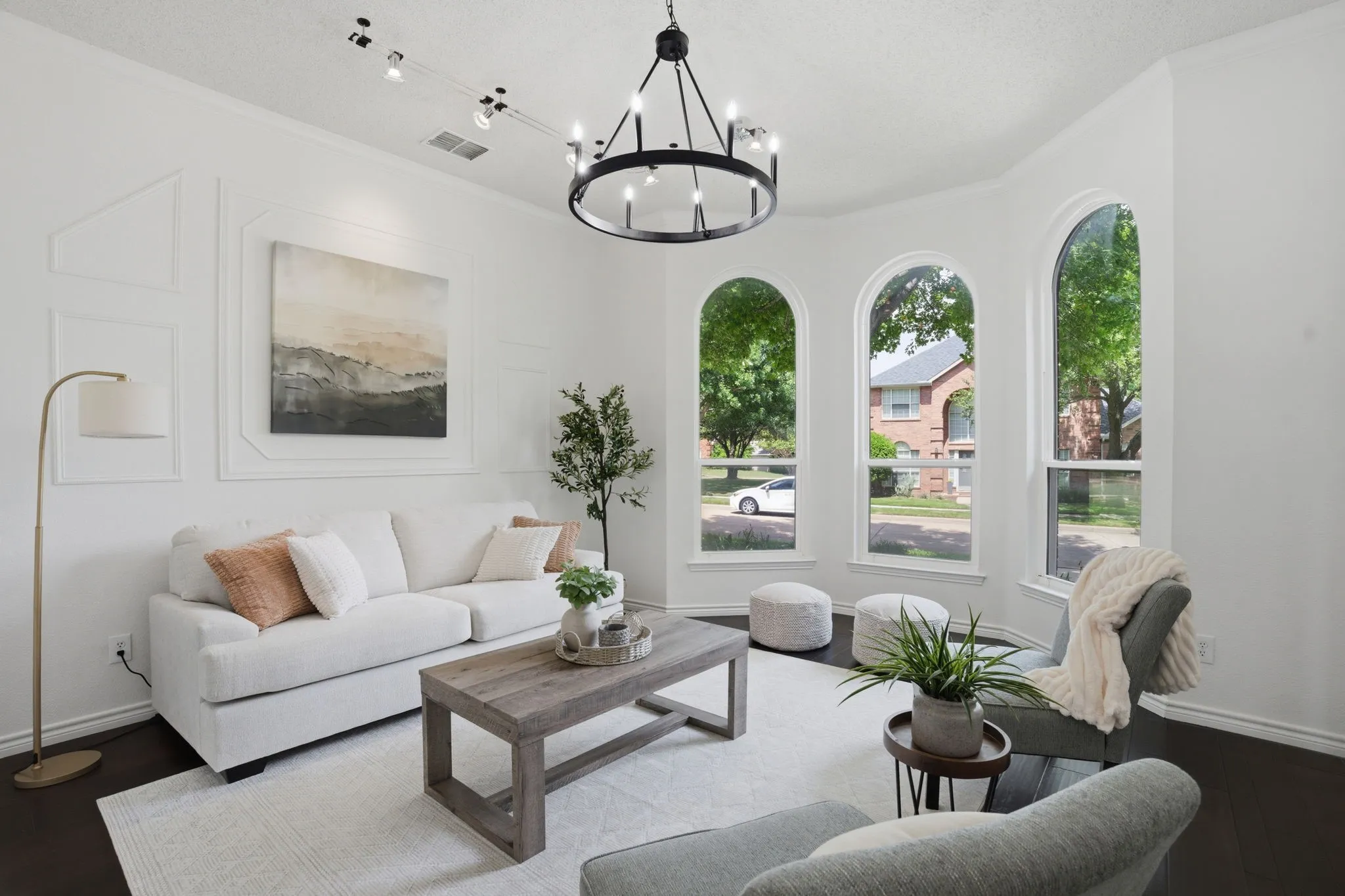 Formal Living space featuring dark wood-finish flooring and a contemporary chandelier