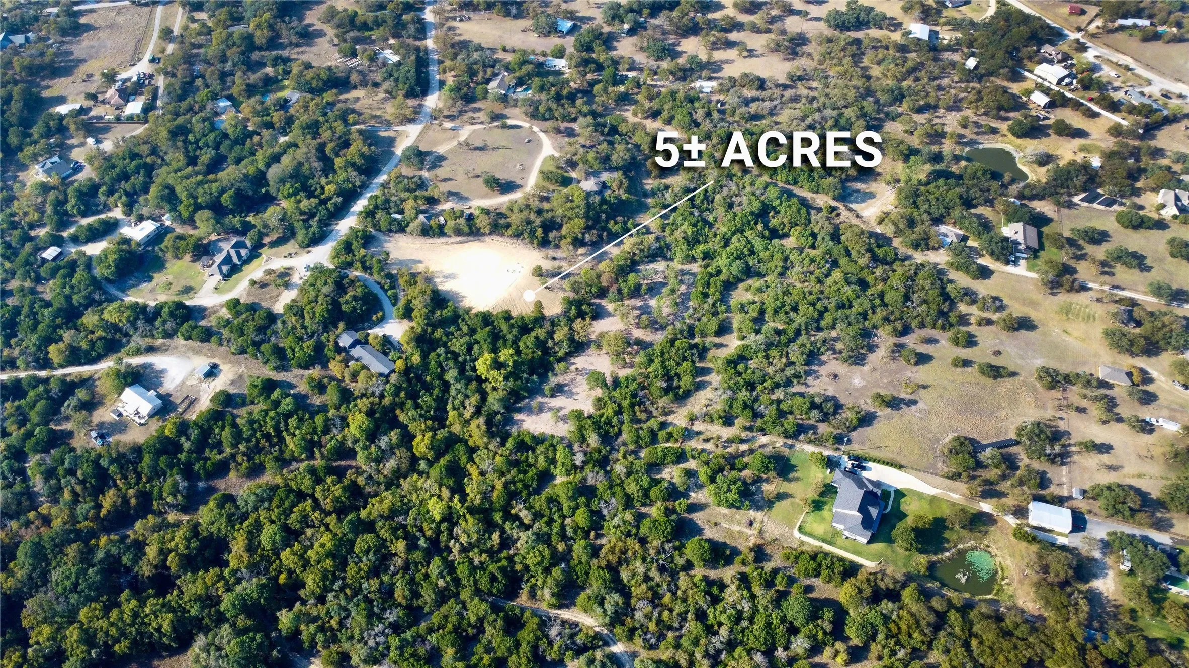 Expansive 5+ acre property featuring mature tree coverage and open land areas