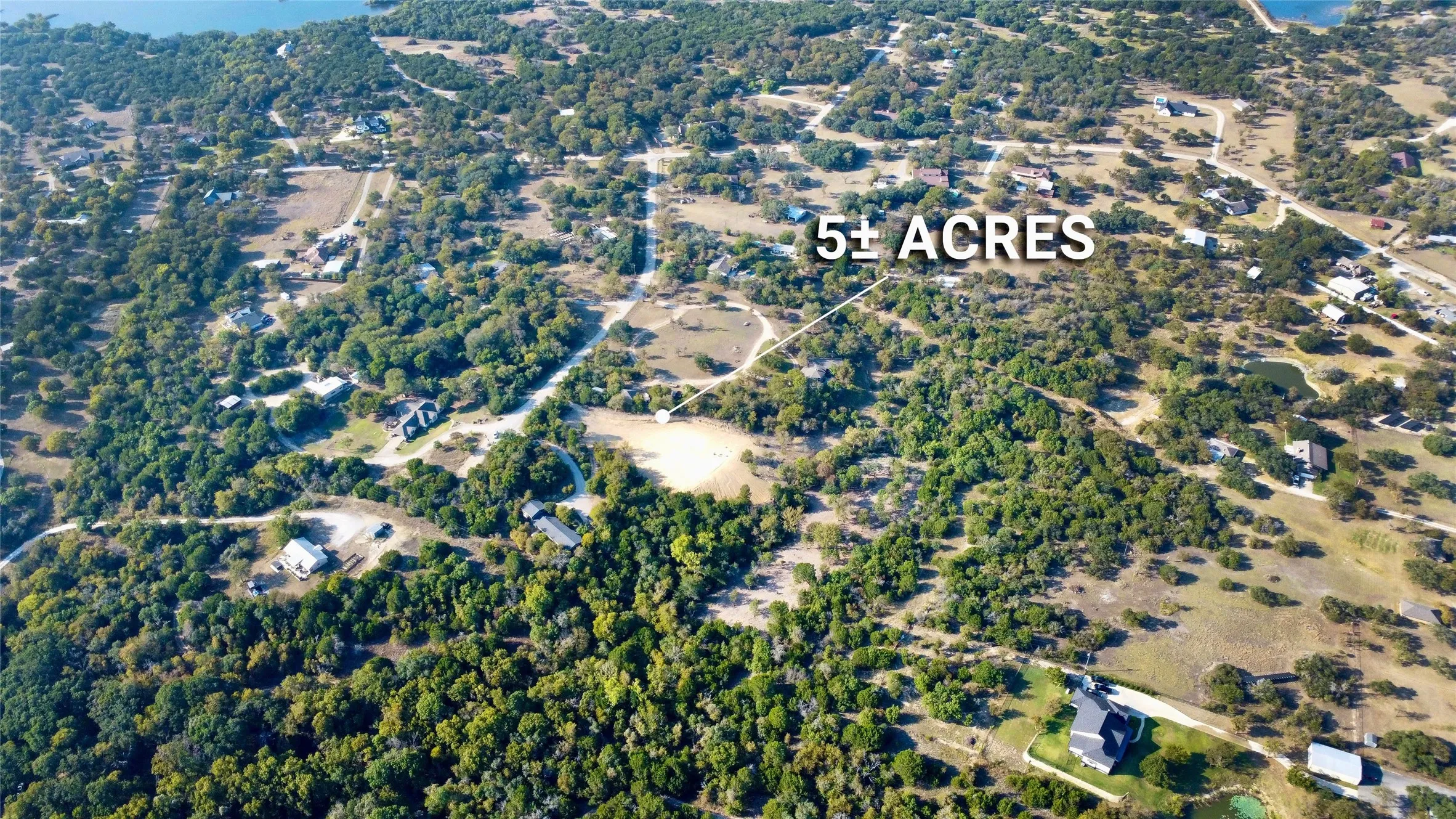 Expansive 5+ acre land parcel featuring varied tree coverage and partially cleared areas