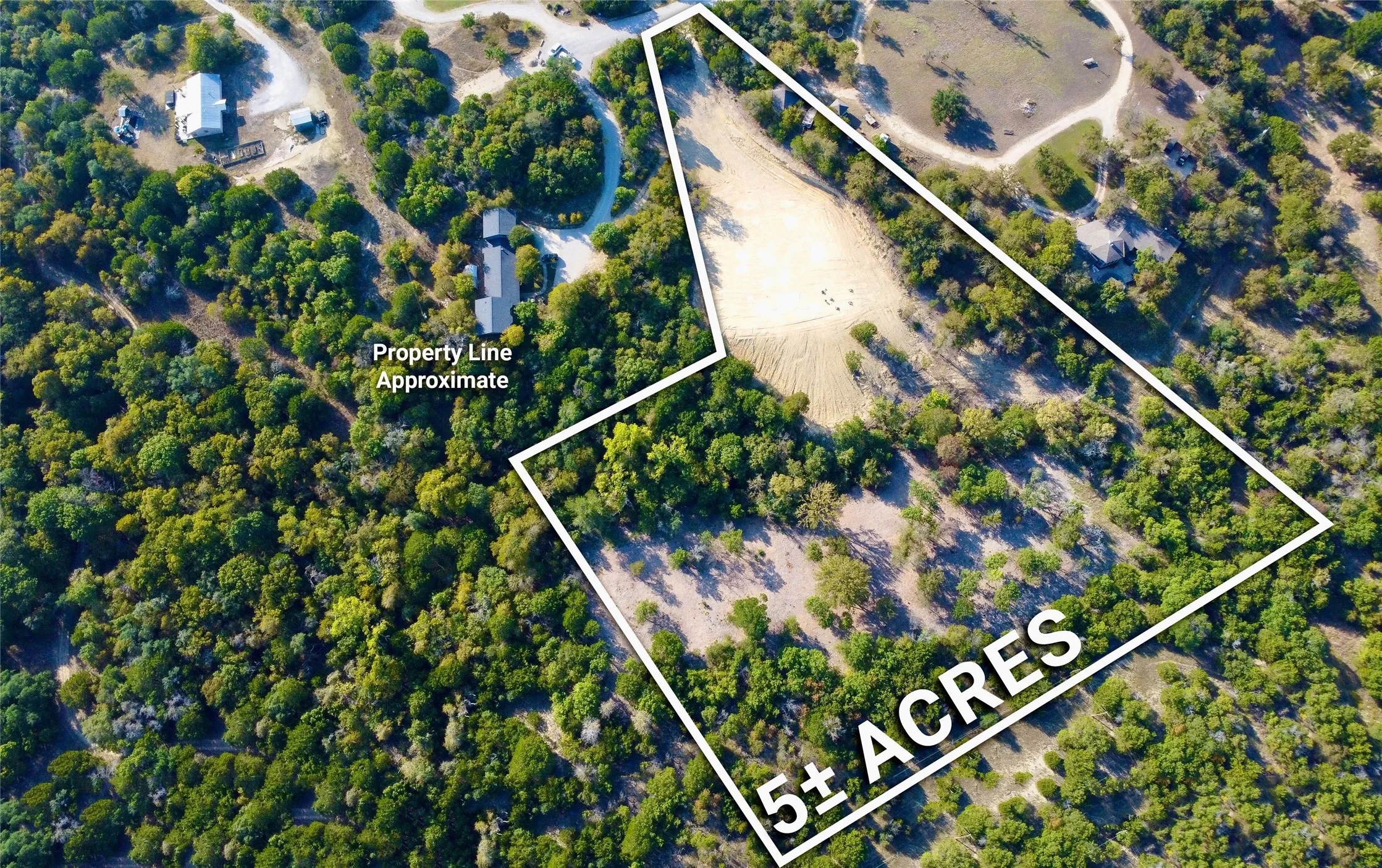 Expansive 5+ acre property featuring a cleared building site and mature tree coverage