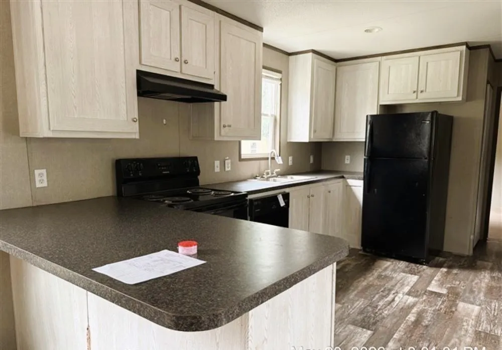 Extended breakfast bar offers plenty of space for meal prep and additional seating.  Natural light from window above sink adds a bright and warm feel.