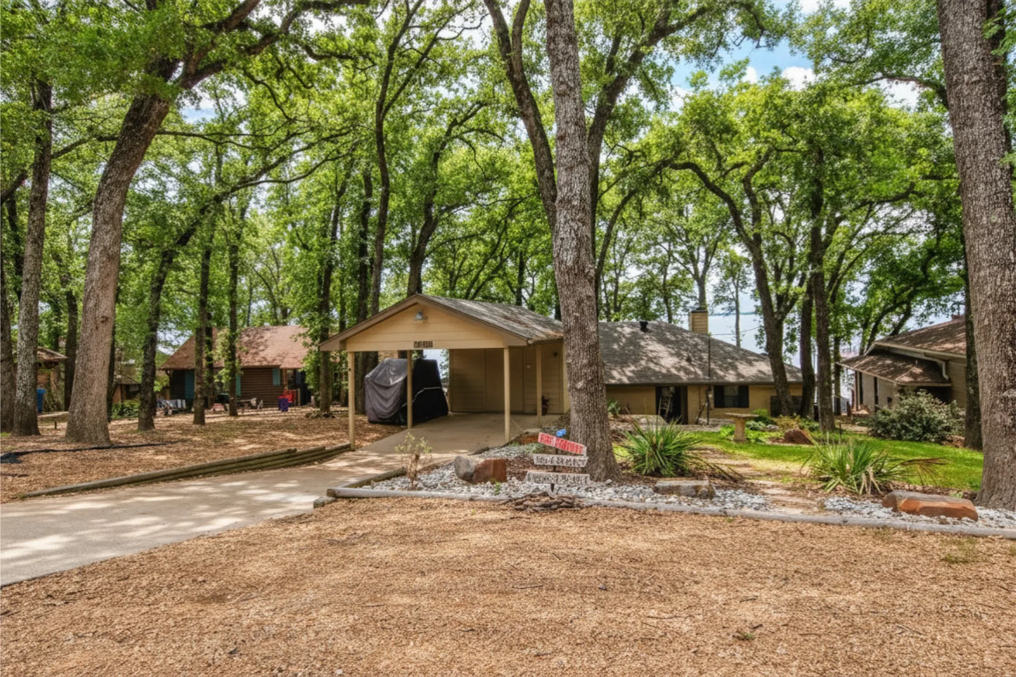 Street Side View. Covered carport parking with storage below and extra parking at street.