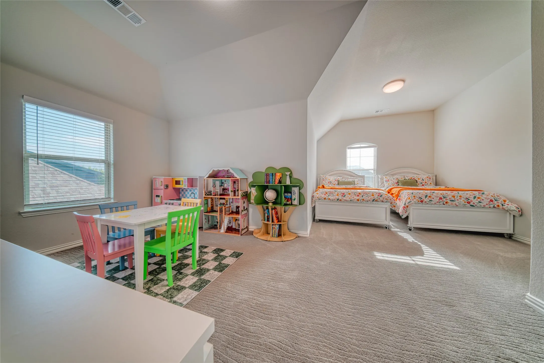Carpeted bedroom featuring lofted ceiling and baseboards