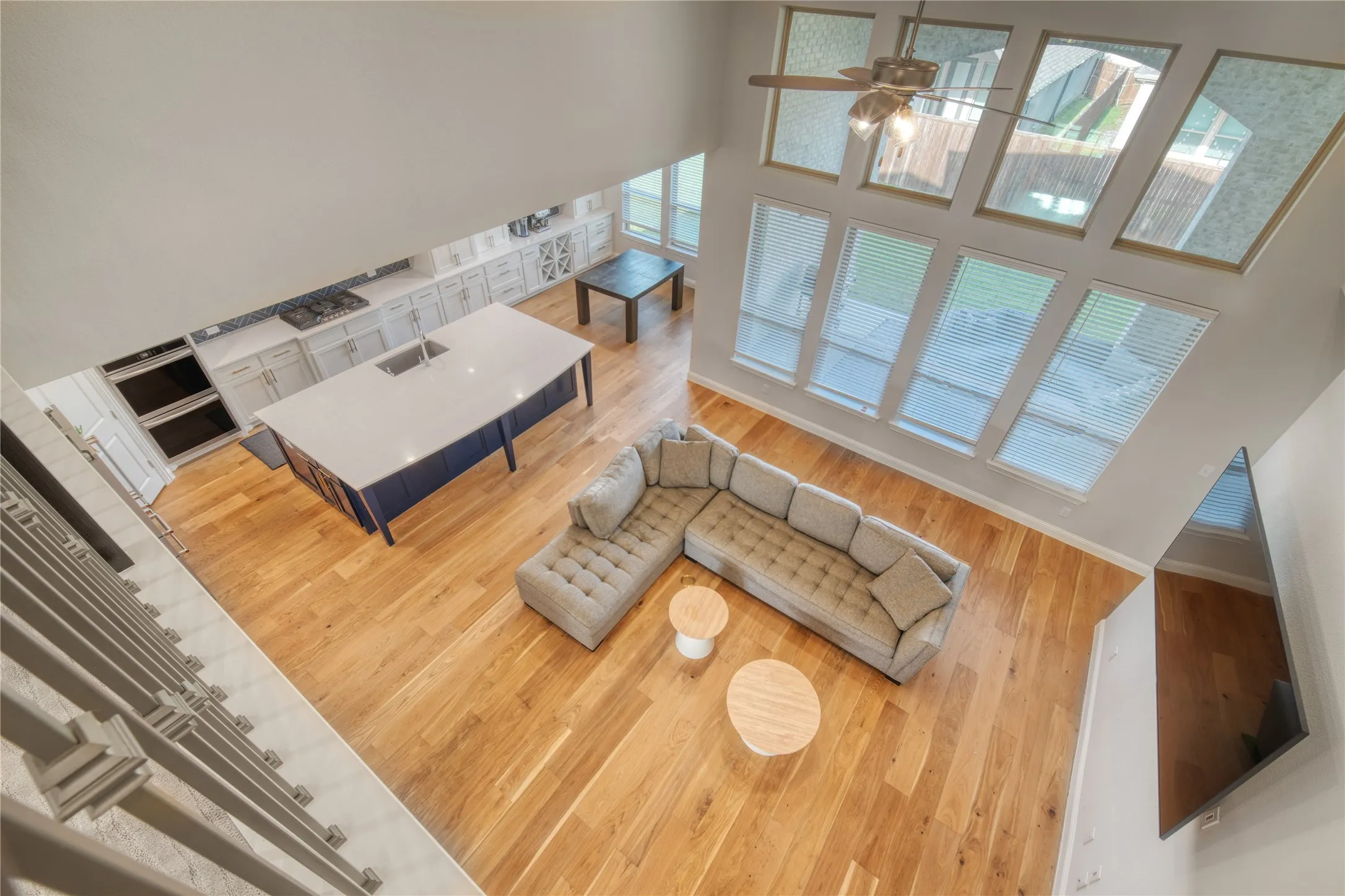 Living room with a towering ceiling and wood finished floors
