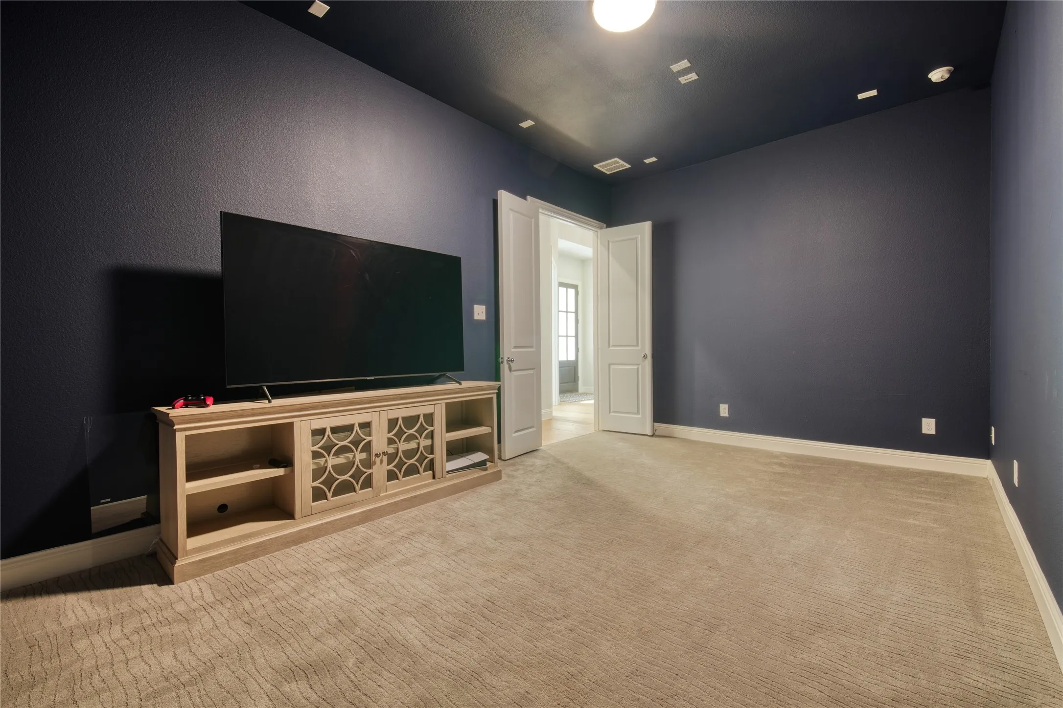 Unfurnished living room with carpet floors and baseboards