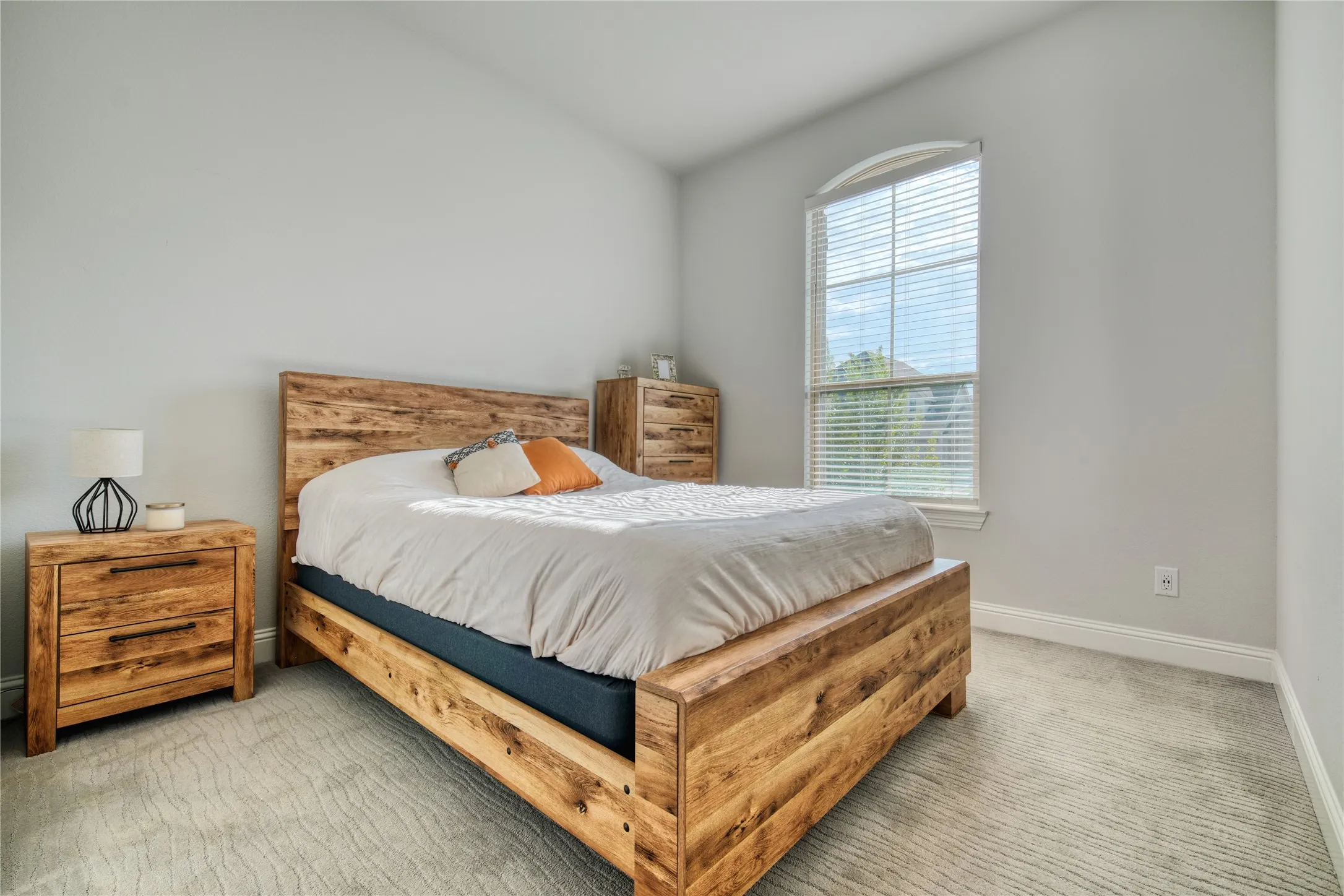 Bedroom featuring light colored carpet and baseboards