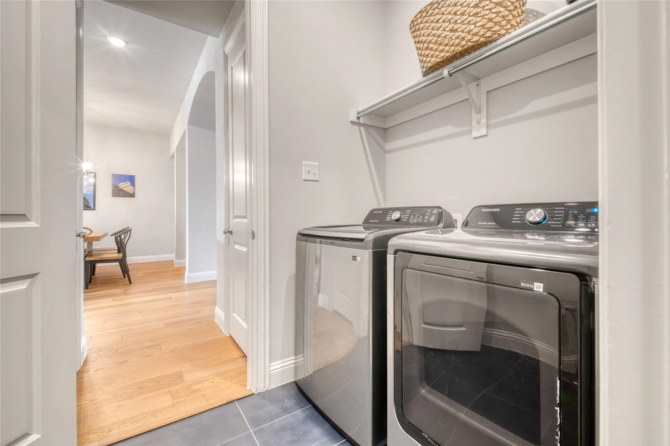 Laundry room featuring washer and clothes dryer and tile patterned floors