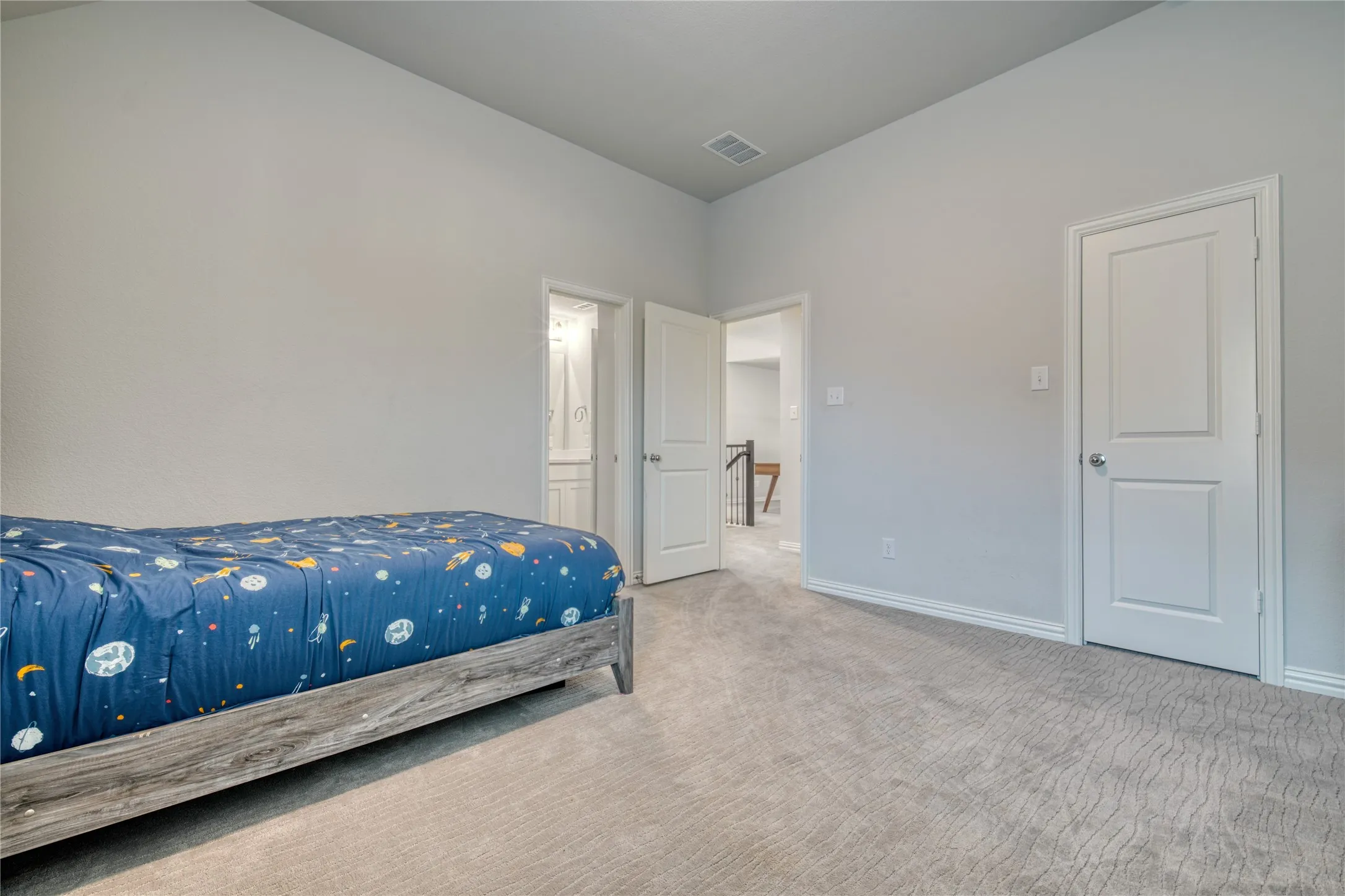 Carpeted bedroom featuring baseboards and ensuite bathroom