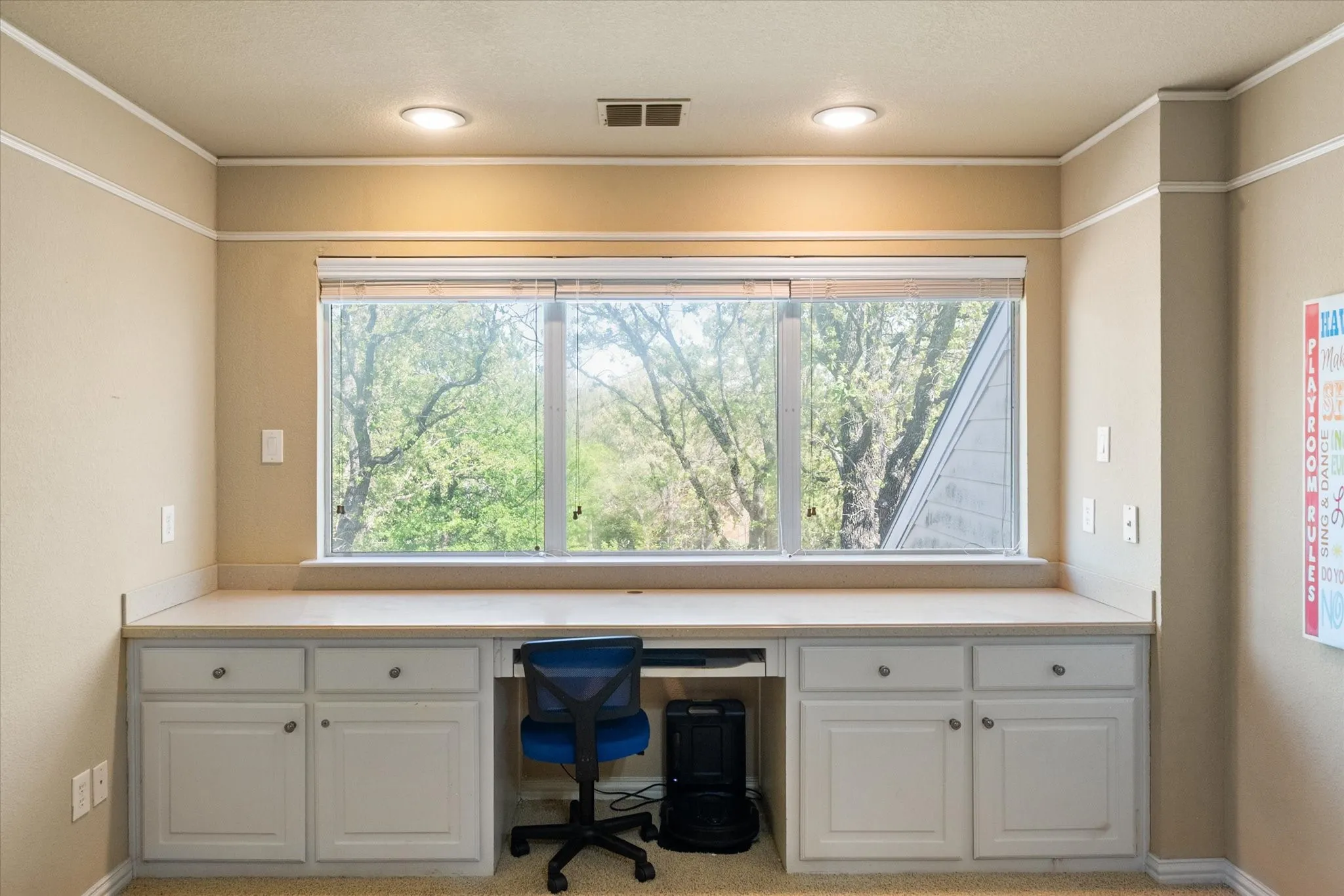 Upstairs living room features built-in desk area for homework, hobby or bill pay. Large windows look out to back yard.