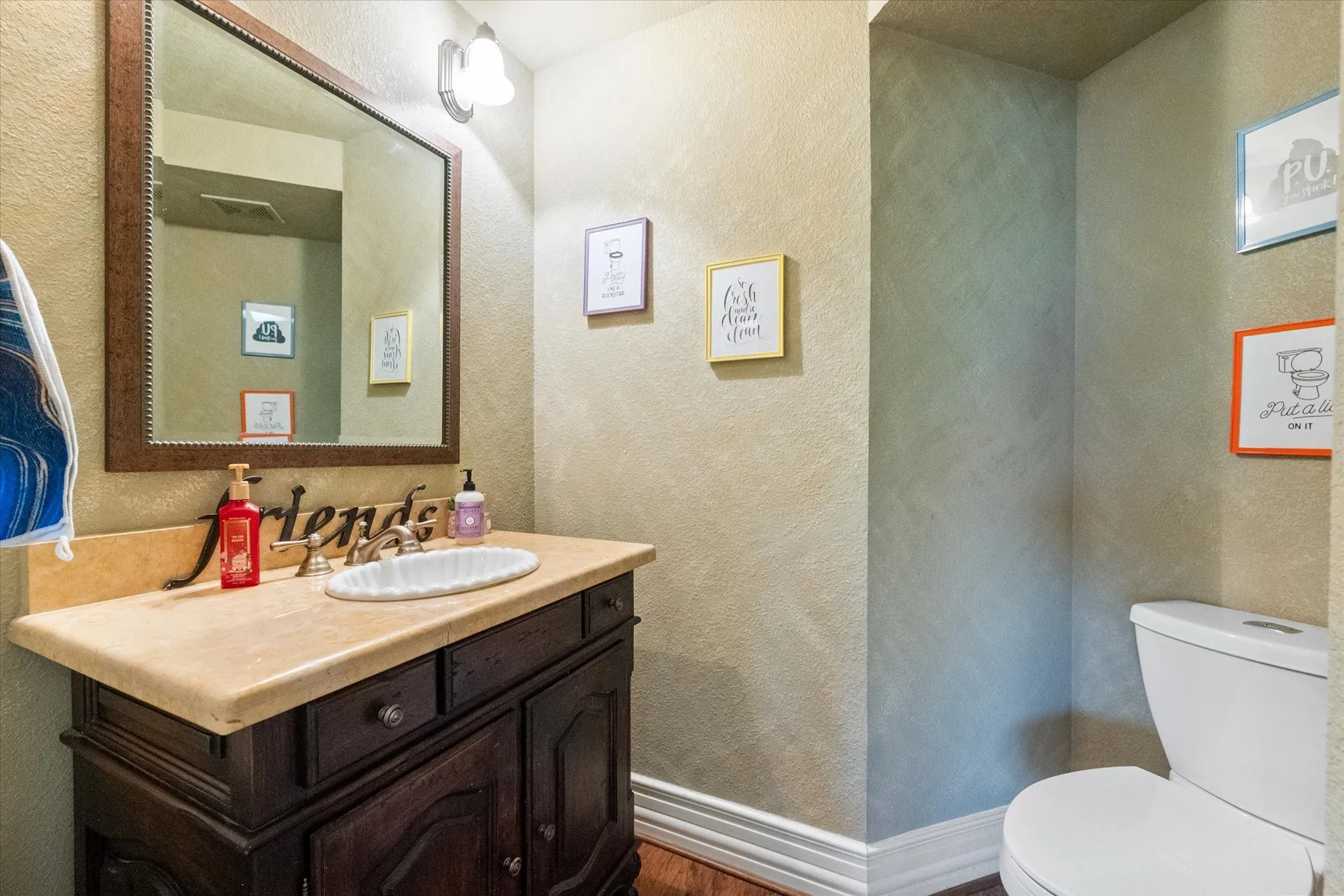 Powder bath downstairs features a single vanity.
