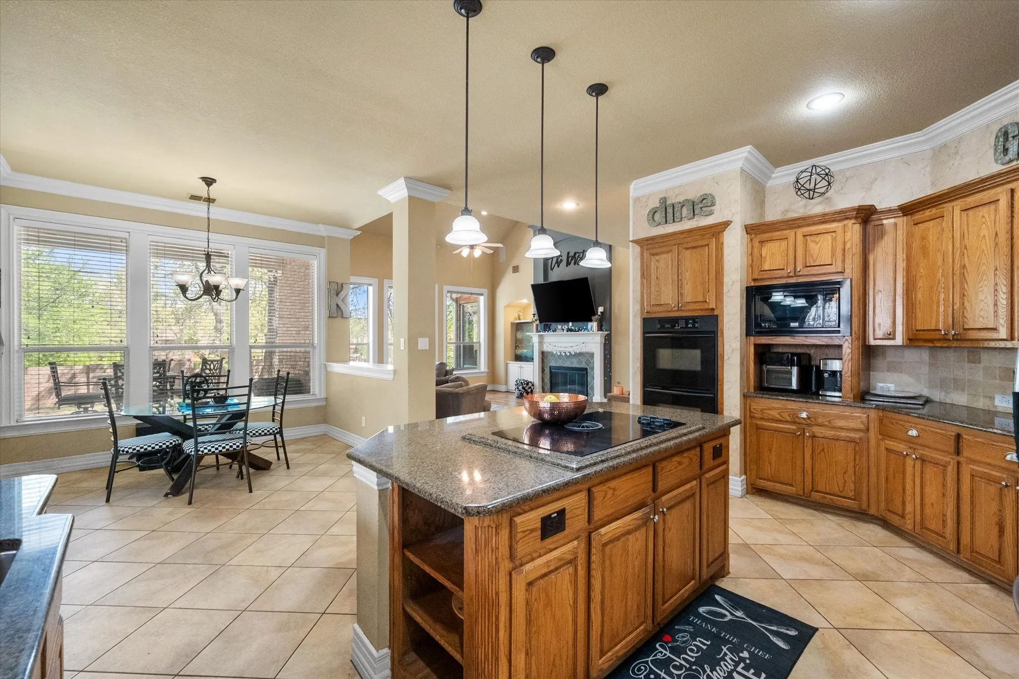 Bright and inviting **open-concept kitchen and breakfast area** featuring **ceramic tile flooring, recessed (can) lighting, and abundant natural light**. The spacious breakfast nook overlooks the **large backyard**, creating the perfect setting for morning coffee or casual dining. The kitchen offers **walk-in pantry storage**, generous cabinetry, and seamless flow into the living spaces—ideal for everyday living and entertaining.