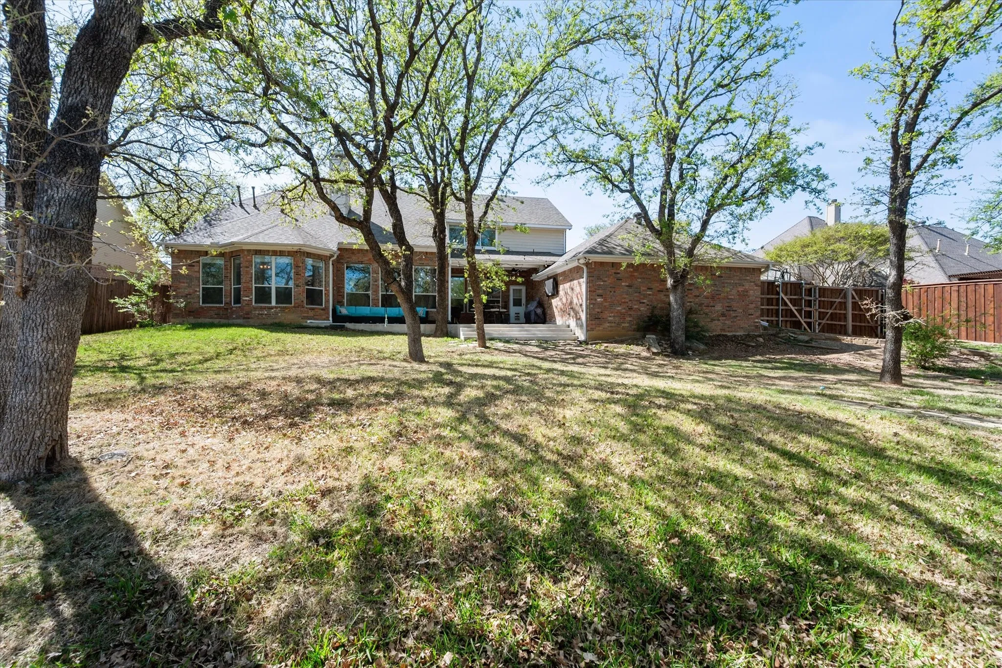 View of the backyard shows oversized private yard. Gardener? No problem. Play space? No problem. Pets? You guessed it, no problem.