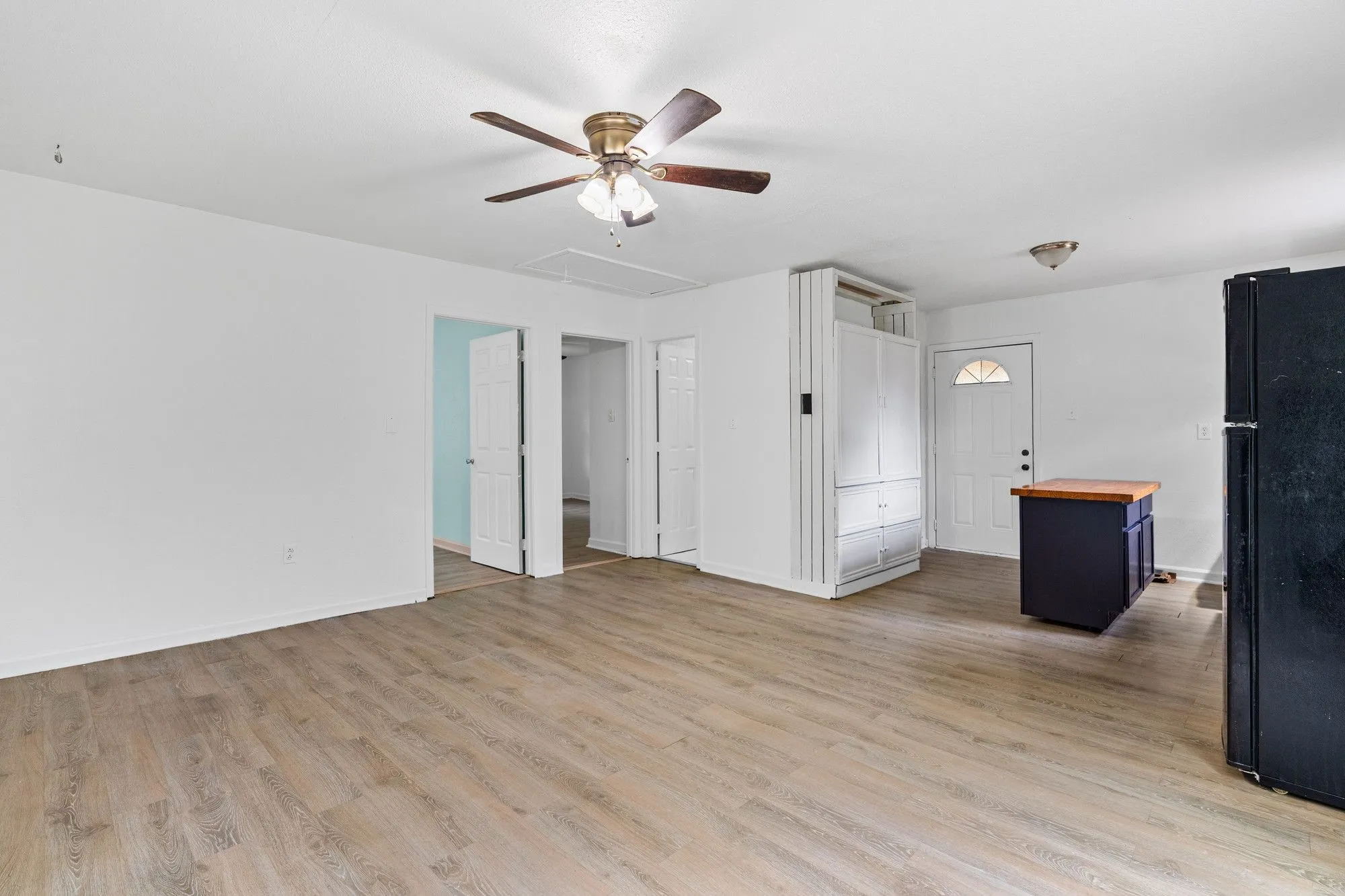Open concept living area with wood-finish flooring