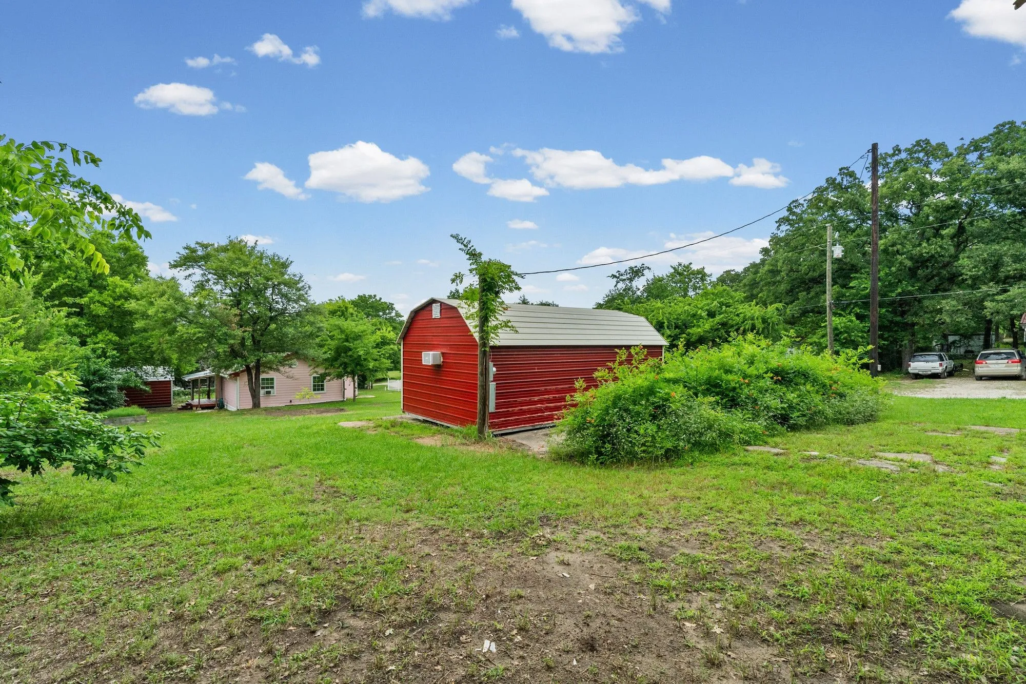 Red barn-style outbuilding with a metal roof