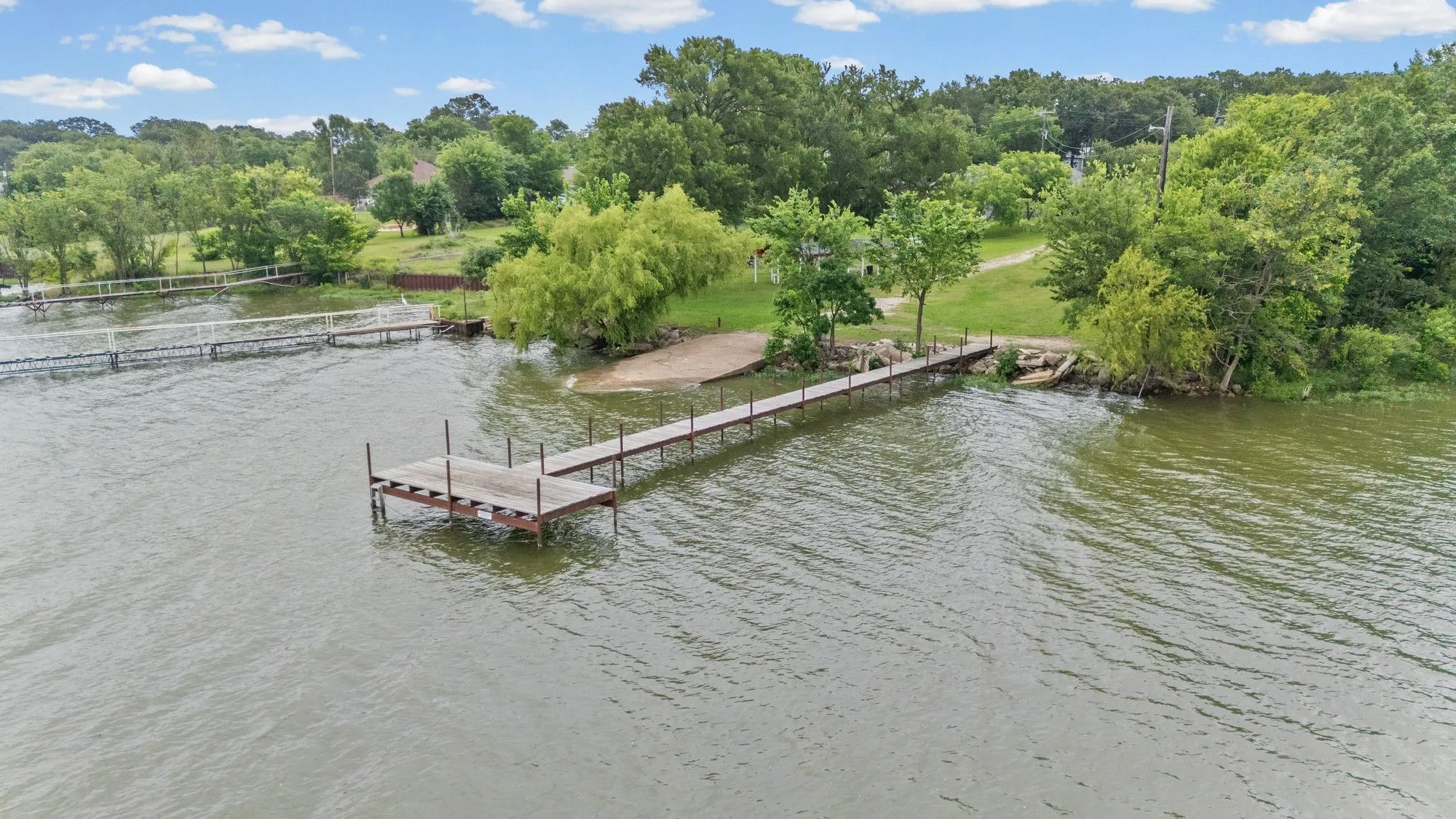 Private dock with a generous platform at HOA Park extending from a sandy shore