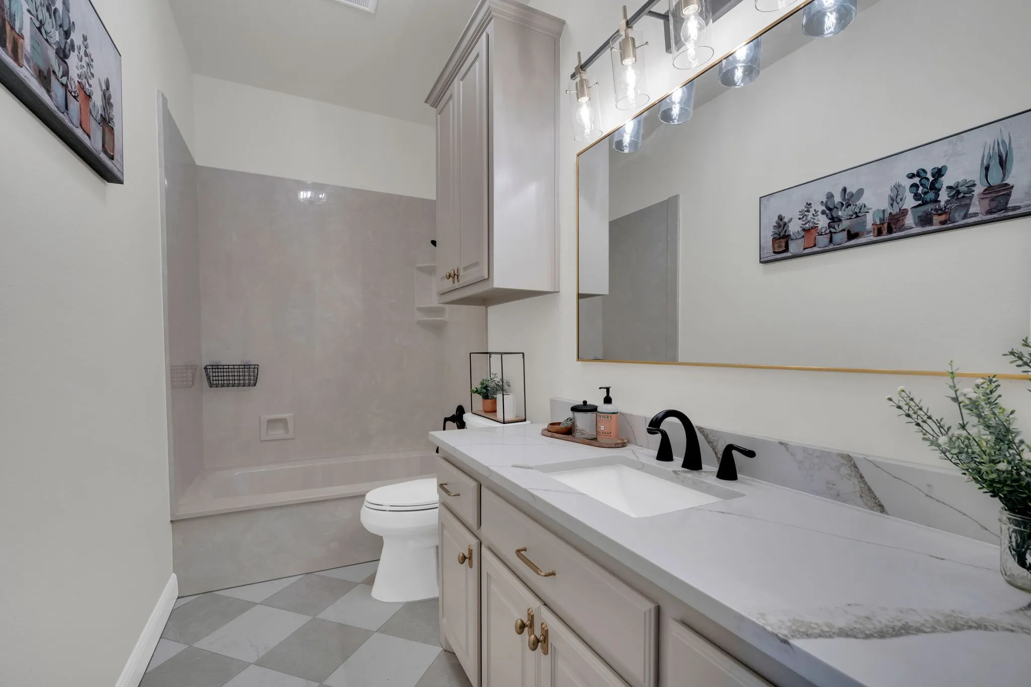 Bathroom 2 featuring a vanity with a single undermount sink, quartz countertop, and a matte black faucet.