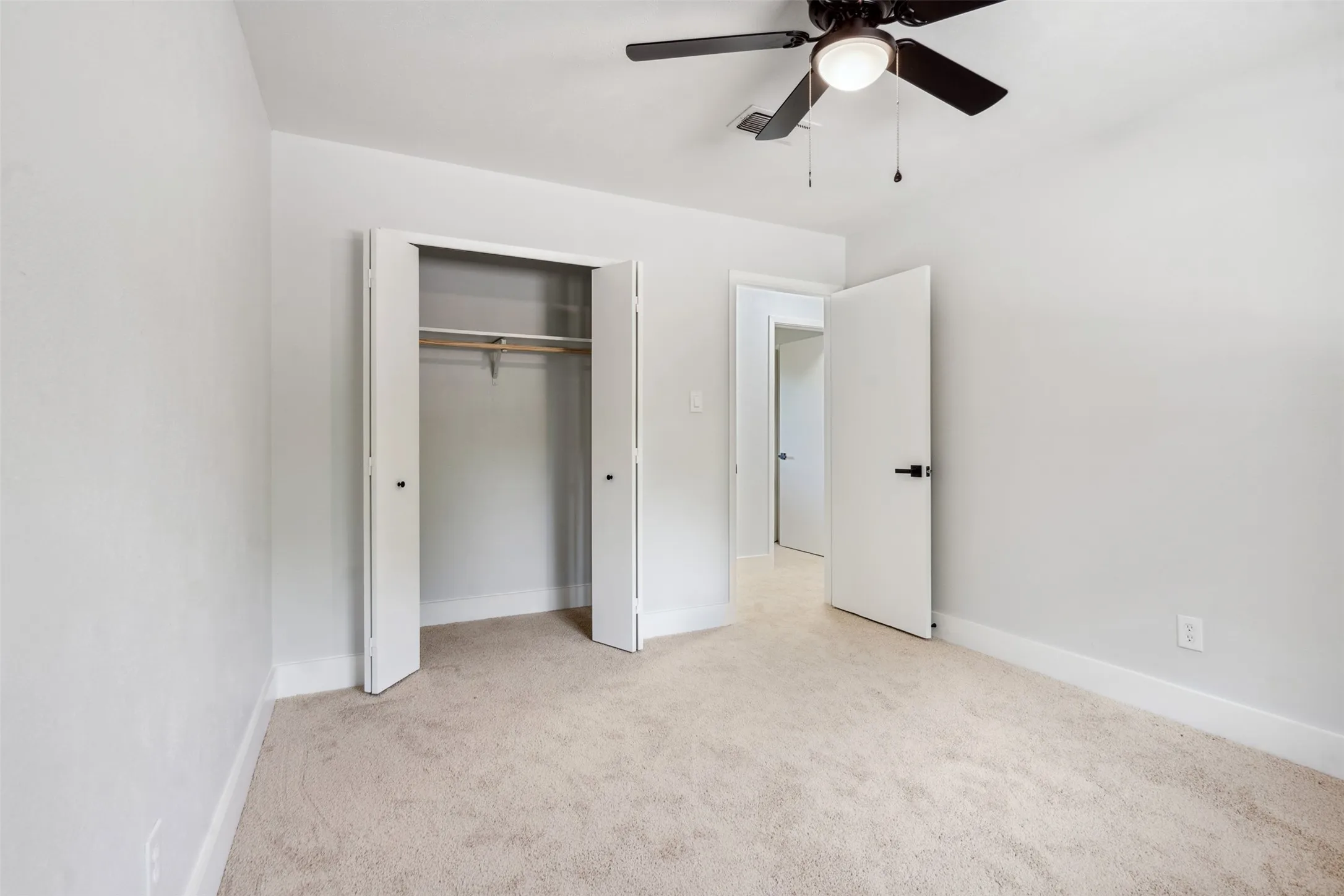 Neutral-toned carpeting complements light wall finishes