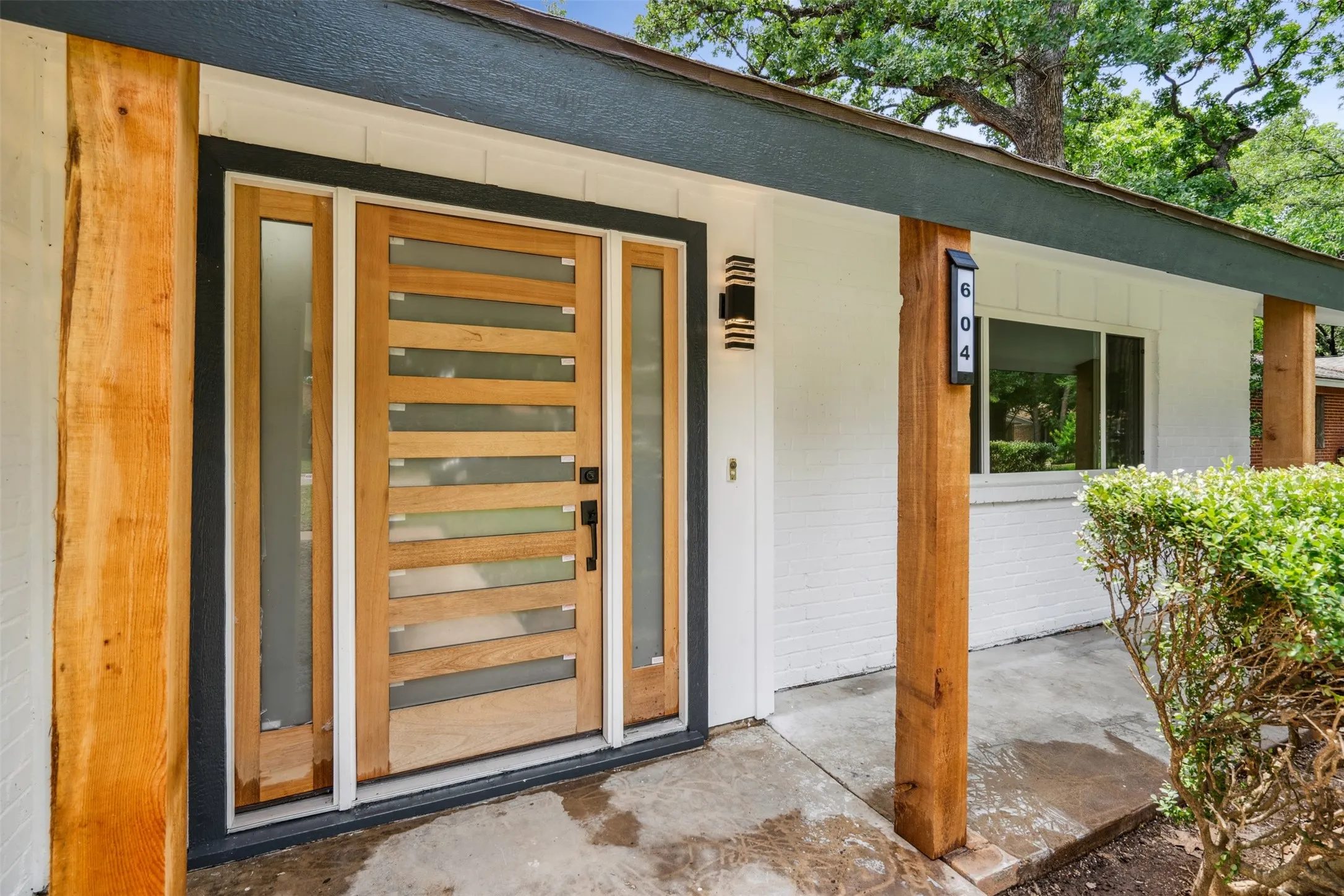 Contemporary wood-panel entry door with horizontal frosted glass inserts