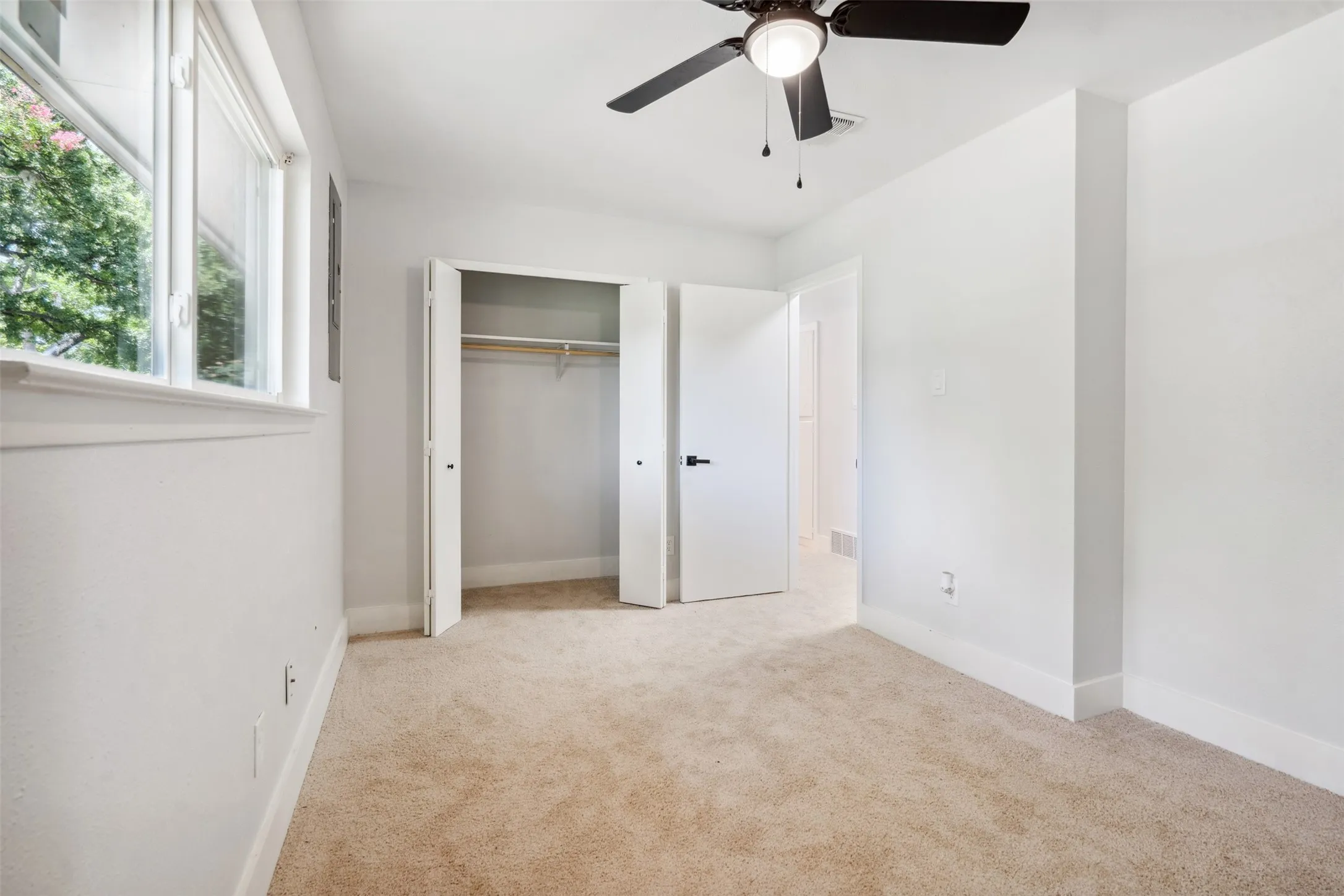 Neutral-toned carpeting complements the white walls and trim