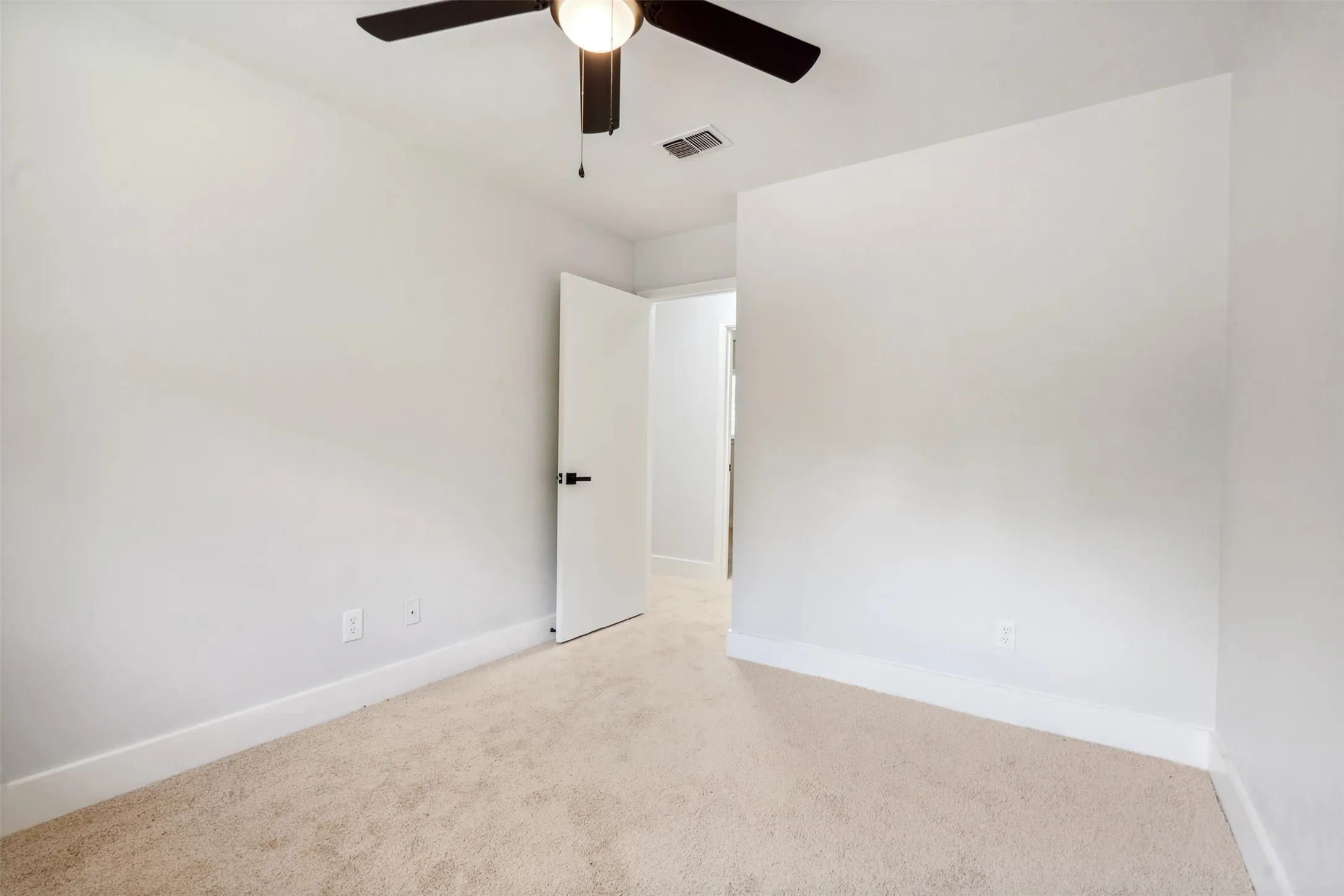 Carpeted interior with light-toned walls