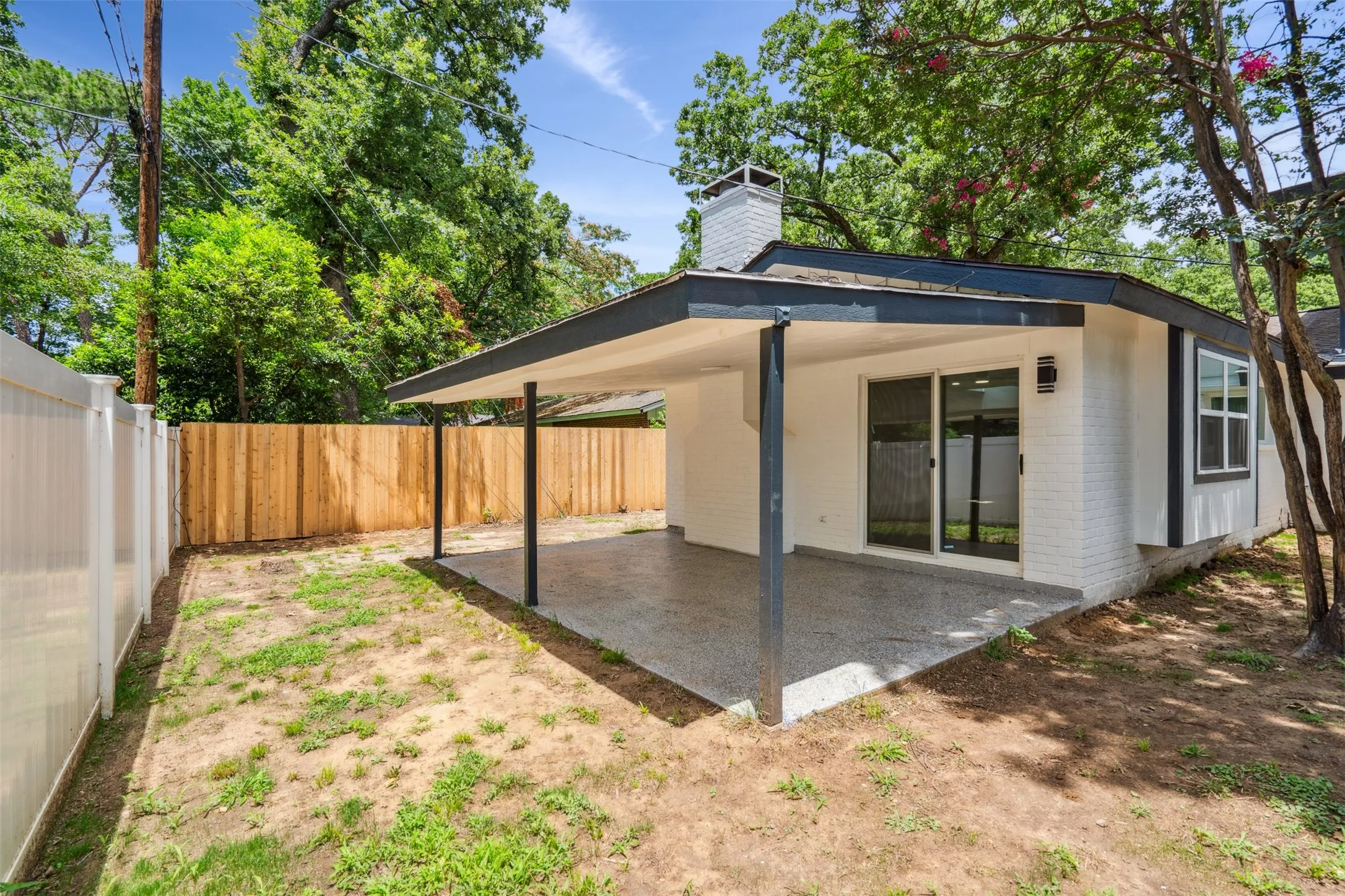 Covered patio with a speckled concrete finish