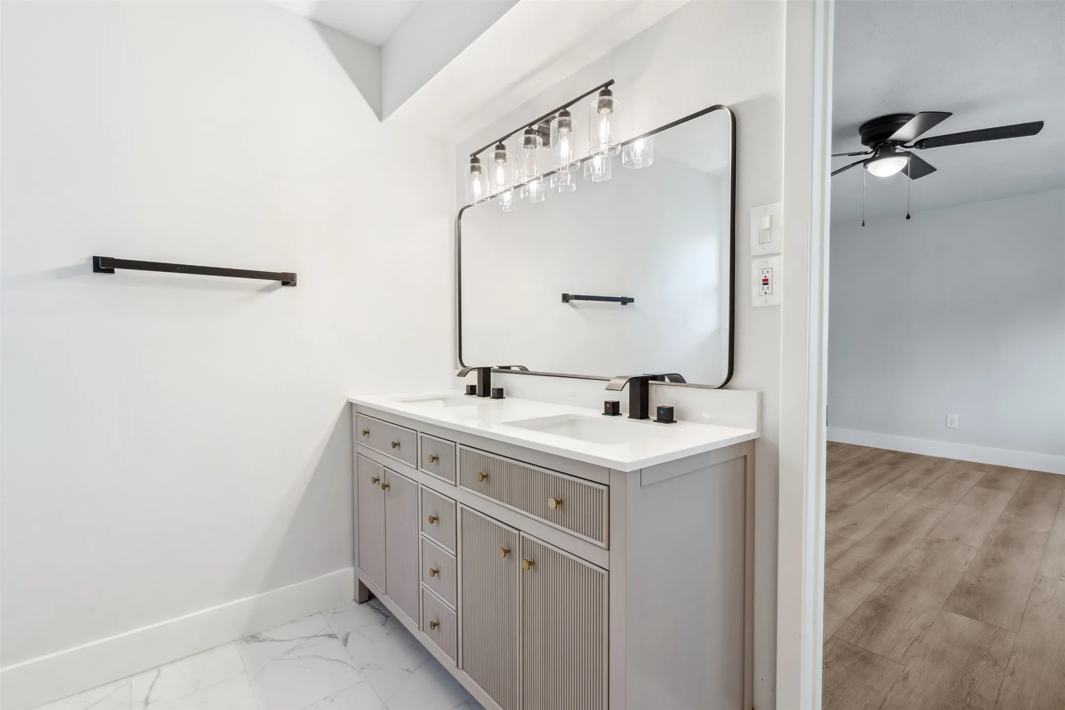 Double vanity with integrated sinks and white countertops
