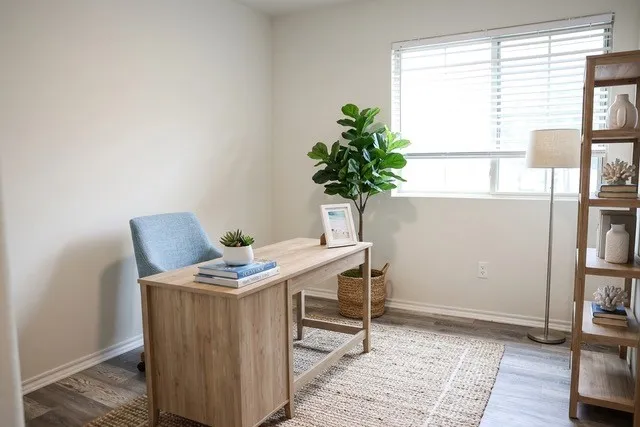 Bright room featuring wood-finish flooring and a single window with blinds